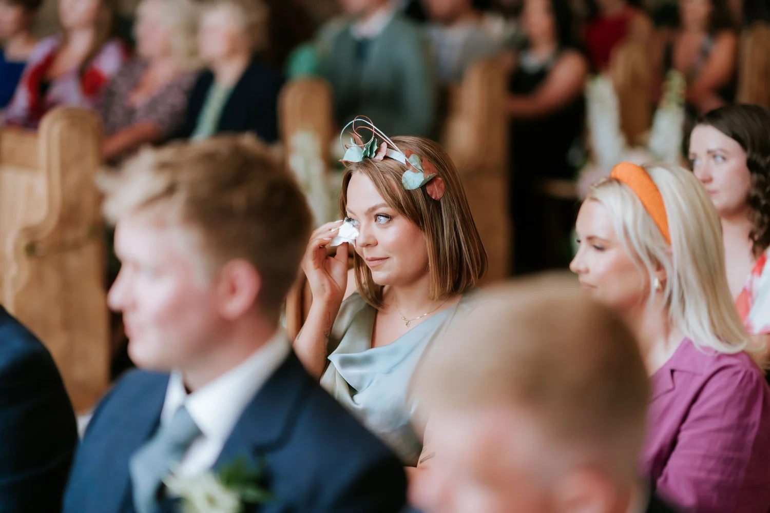 A guest wiping away a tear during the ceremony.