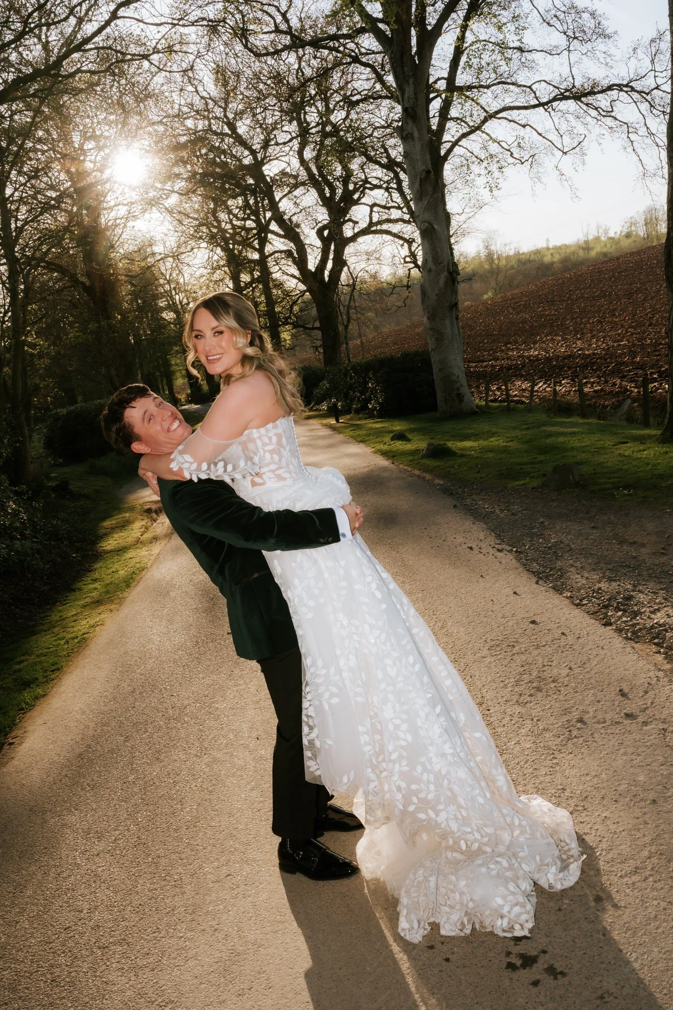 Jonathon lifting Ciara during their portraits in the grounds.