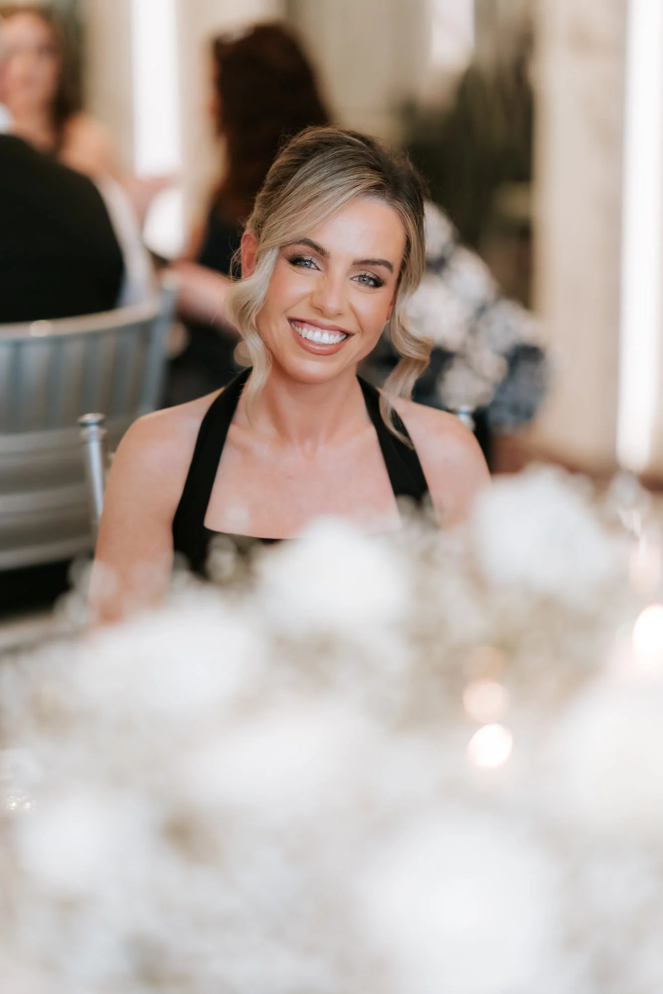 A blonde bridesmaid smiling during the reception