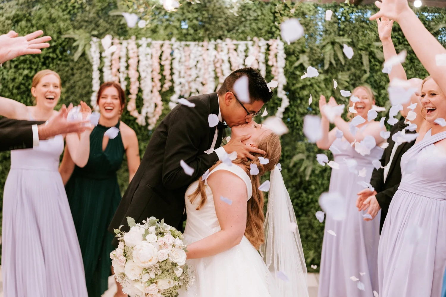 Carl dipping Allie for a kiss beneath a shower of white confetti.