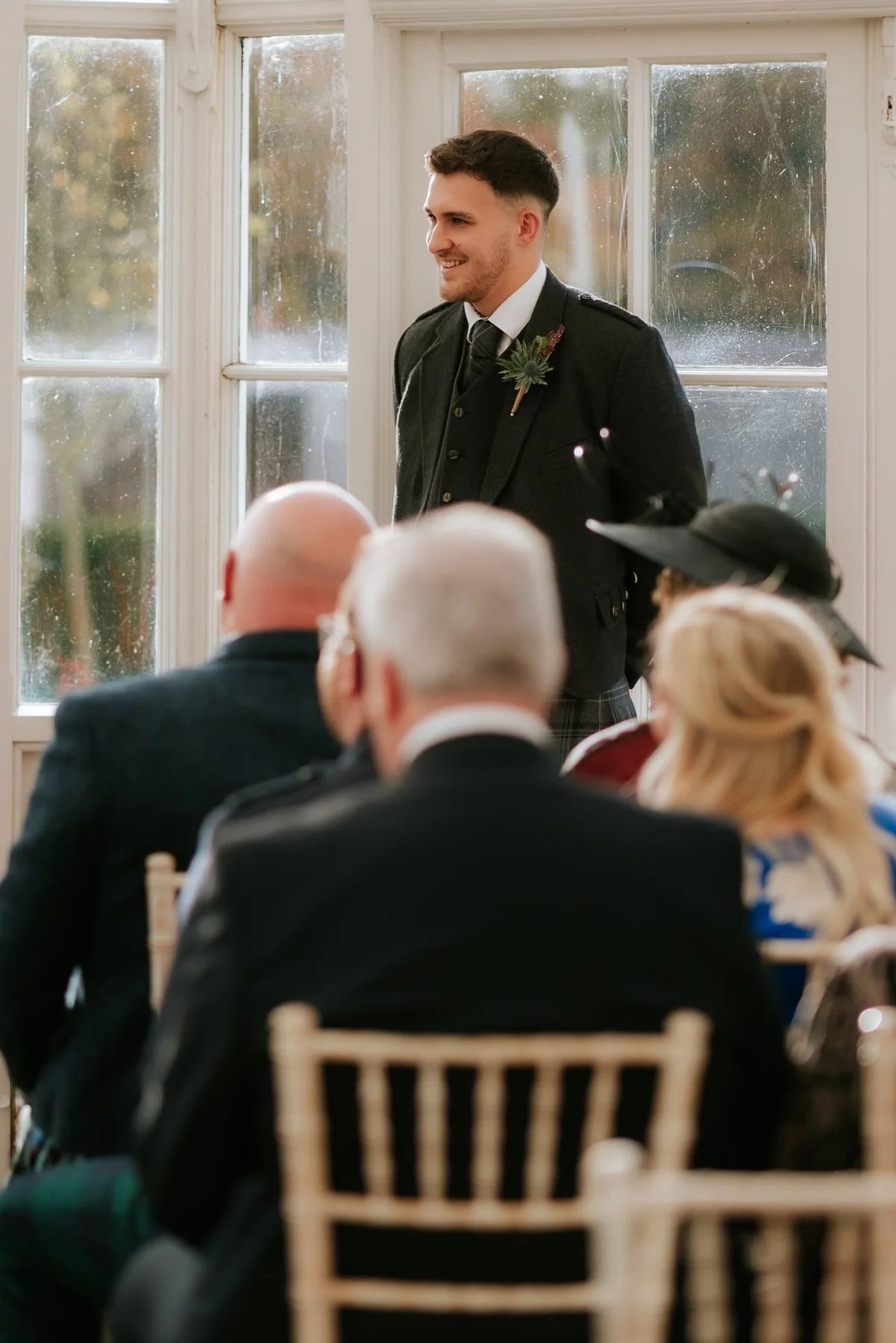 Simon Houston speaking to the seated guests during Kendall and Ewen’s wedding ceremony.