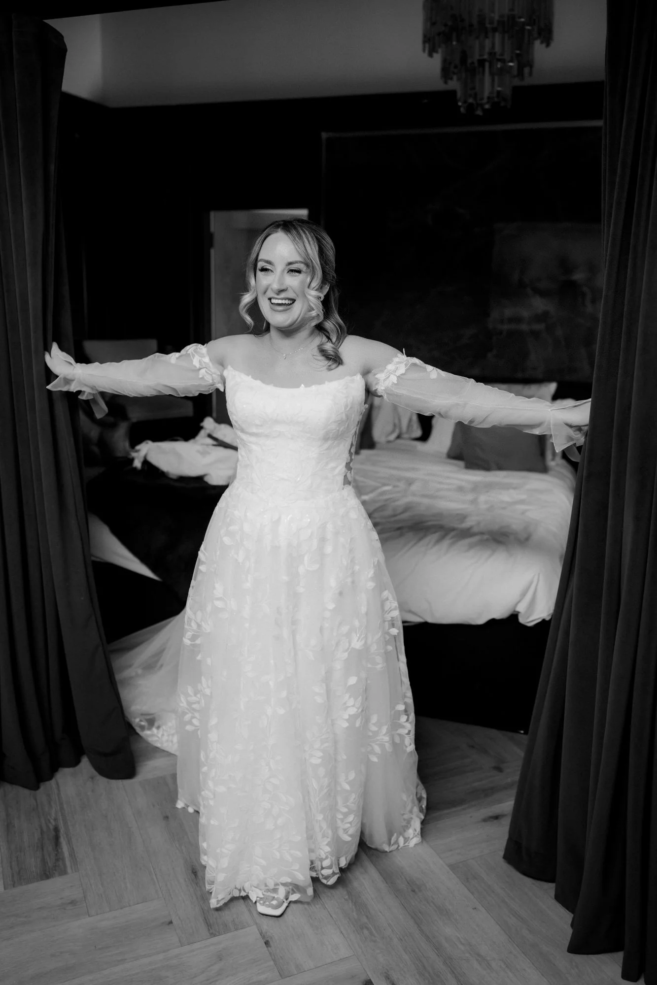 Ciara opening the curtains in her wedding dress.