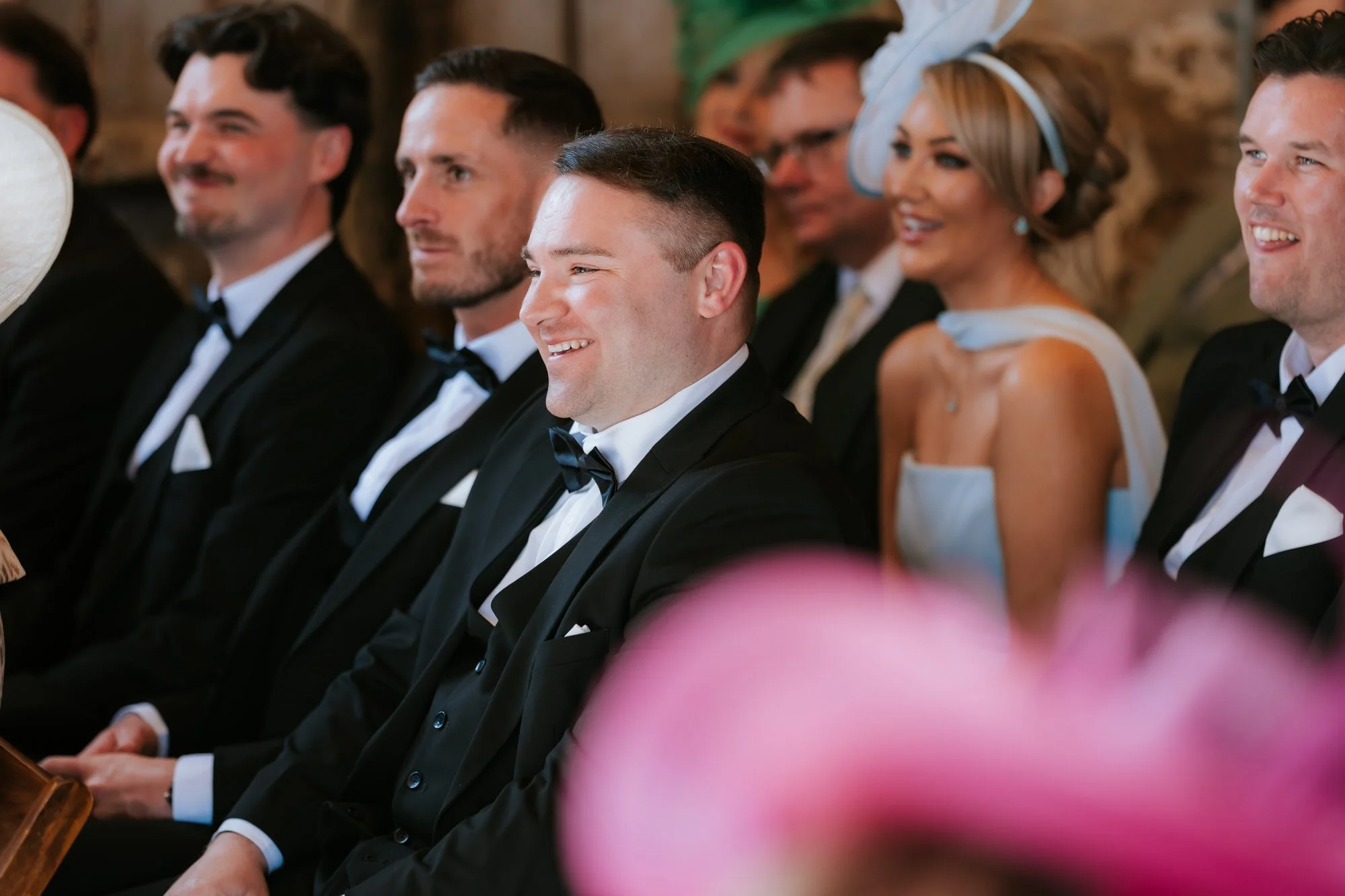 Groomsmen smiling during Natalie and Jamie's ceremony