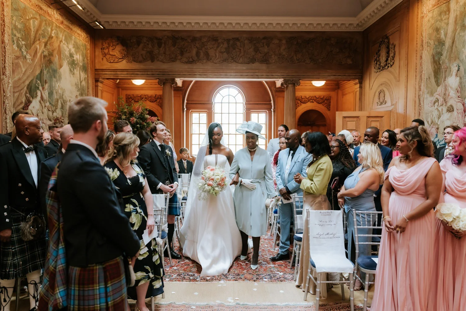 Kuda and her mum walking down the aisle towards Jamie in the Tapestry Room.