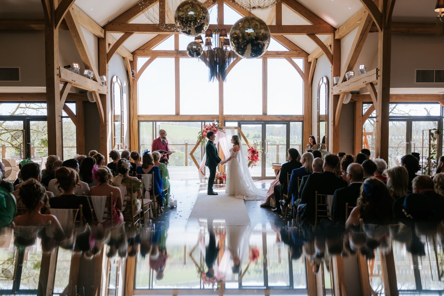 A wide view of the wedding ceremony in Enterkine’s Oak and Glass Pavilion.