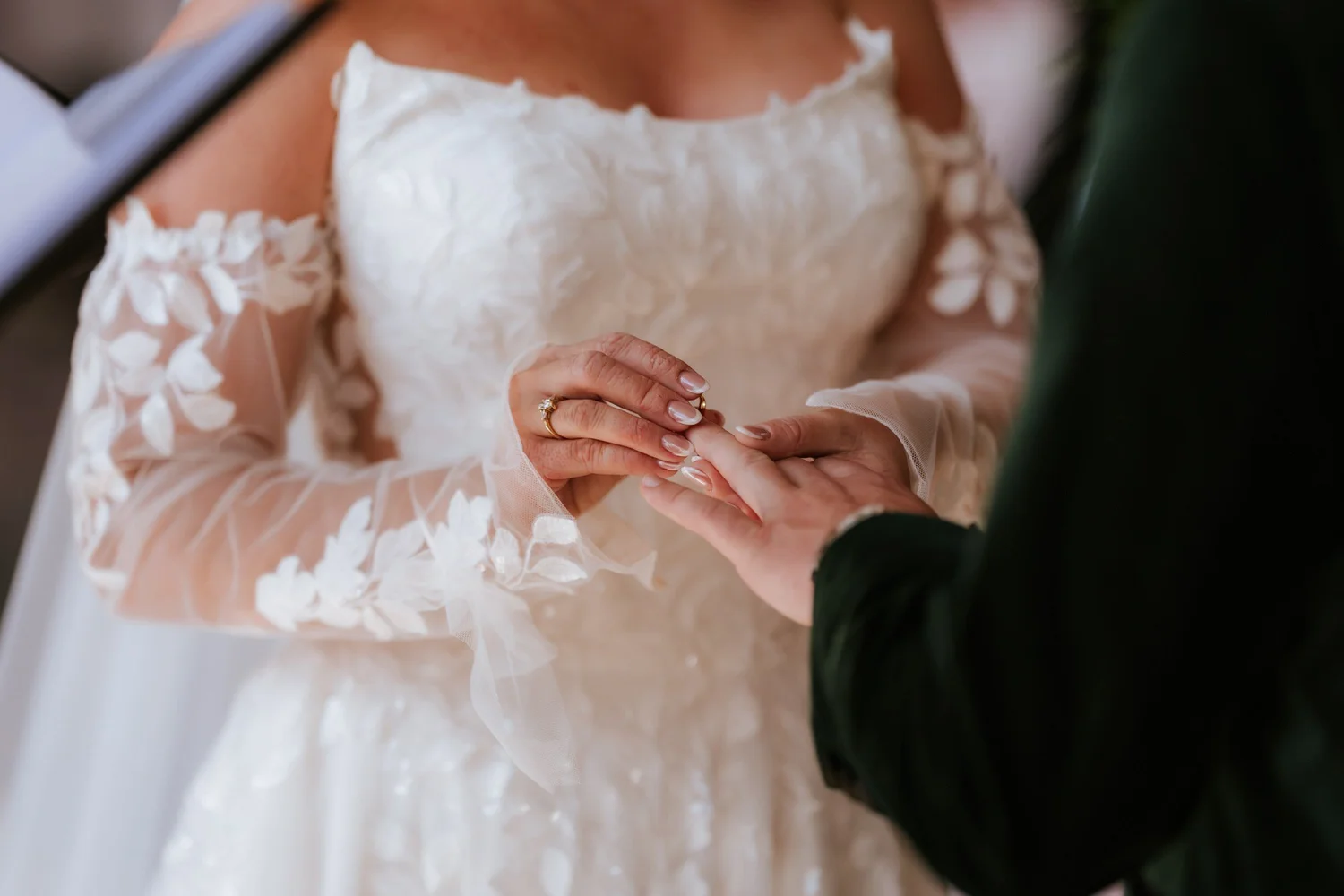A close view of the wedding ring exchange.