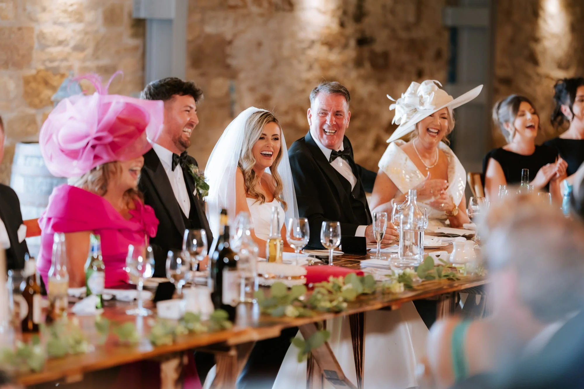 The top table laughing together during the wedding speeches