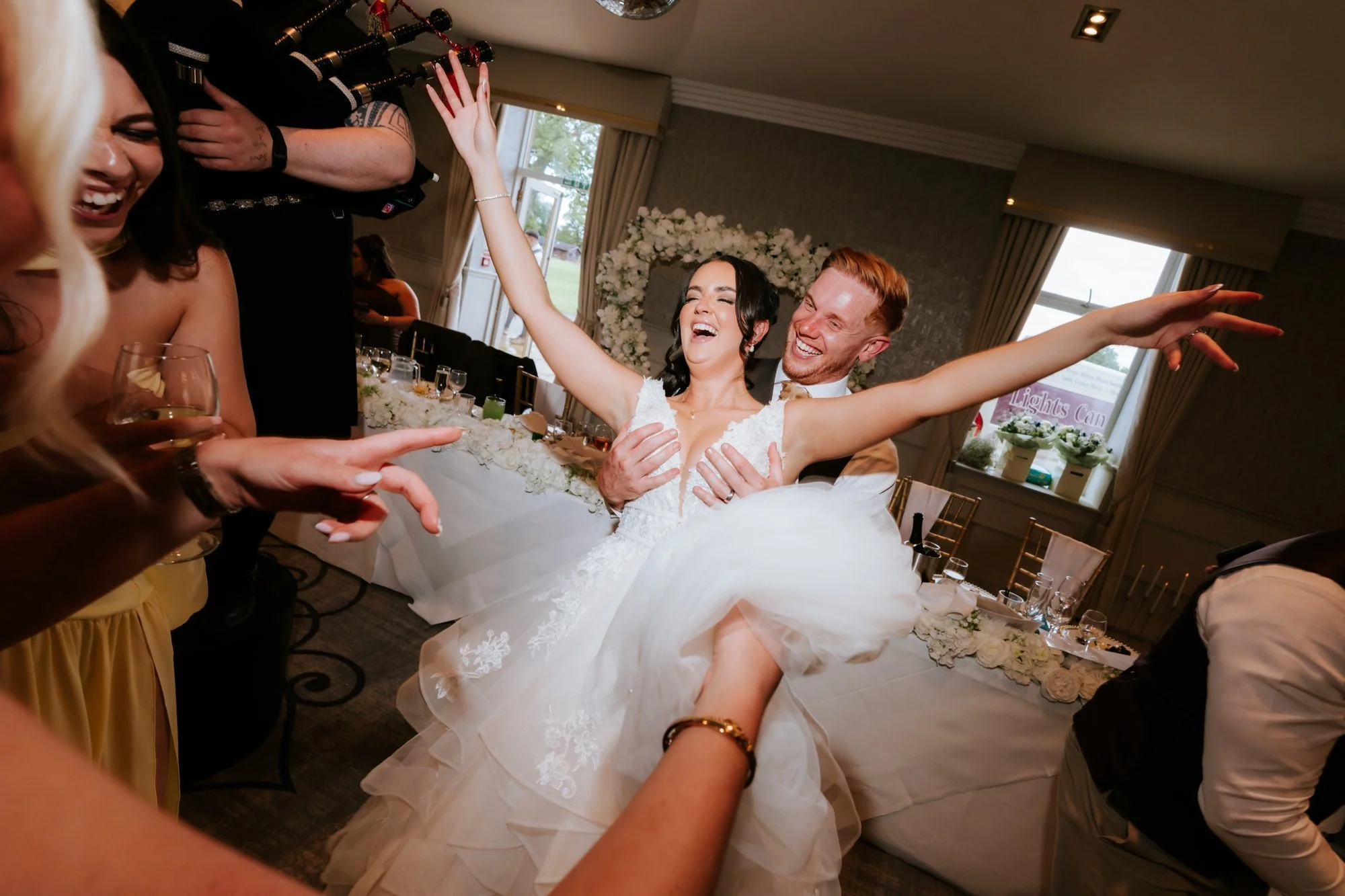 Scott lifting Kaitlyn as she throws her arms out during the celebrations at Glenbervie House.