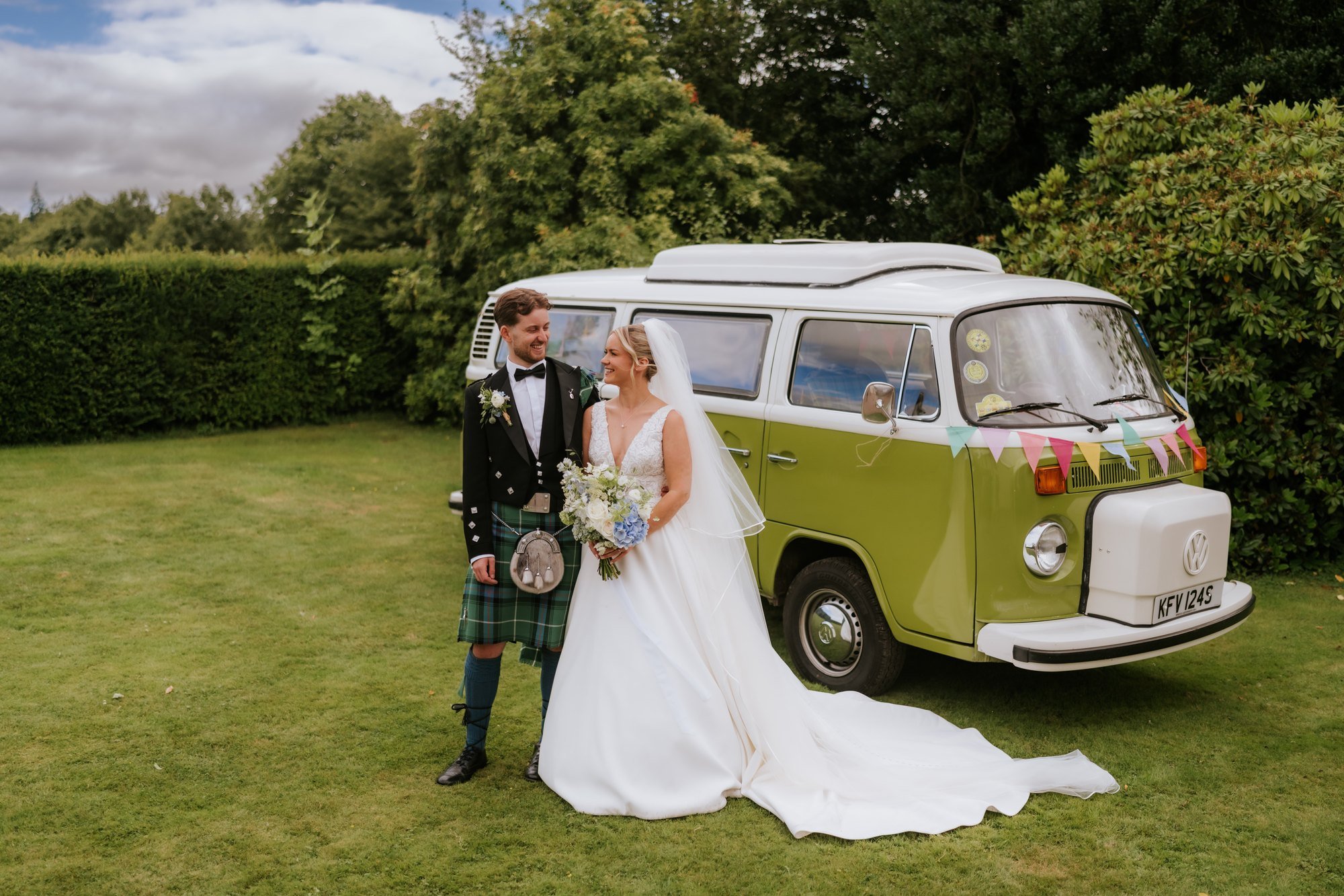 Lilian and Luke together beside a green vintage campervan at Rossie on the Earn.