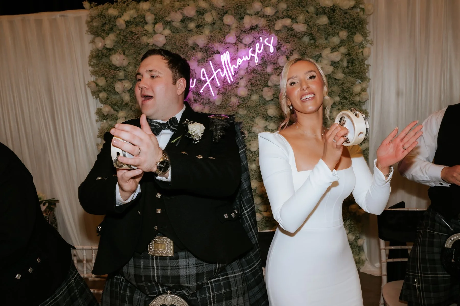 Jordan and Jen clapping and singing along at their wedding breakfast.