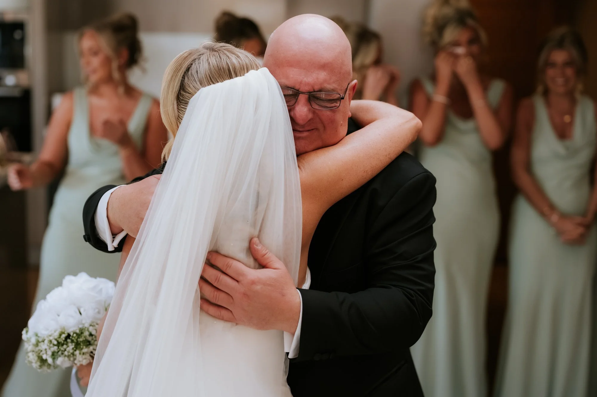 Taylor sharing an emotional hug before the wedding ceremony.