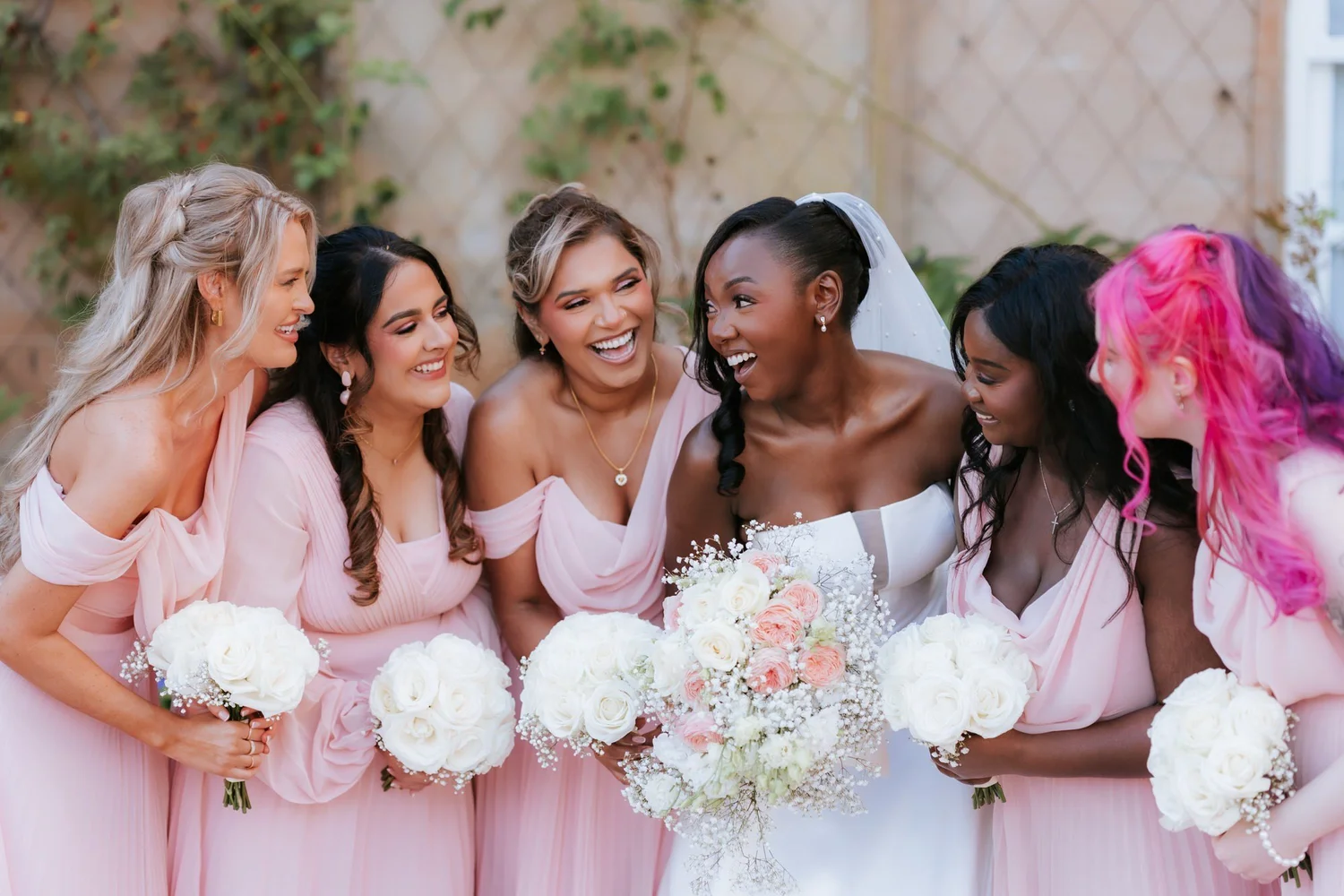 Kuda and her bridesmaids laughing together.