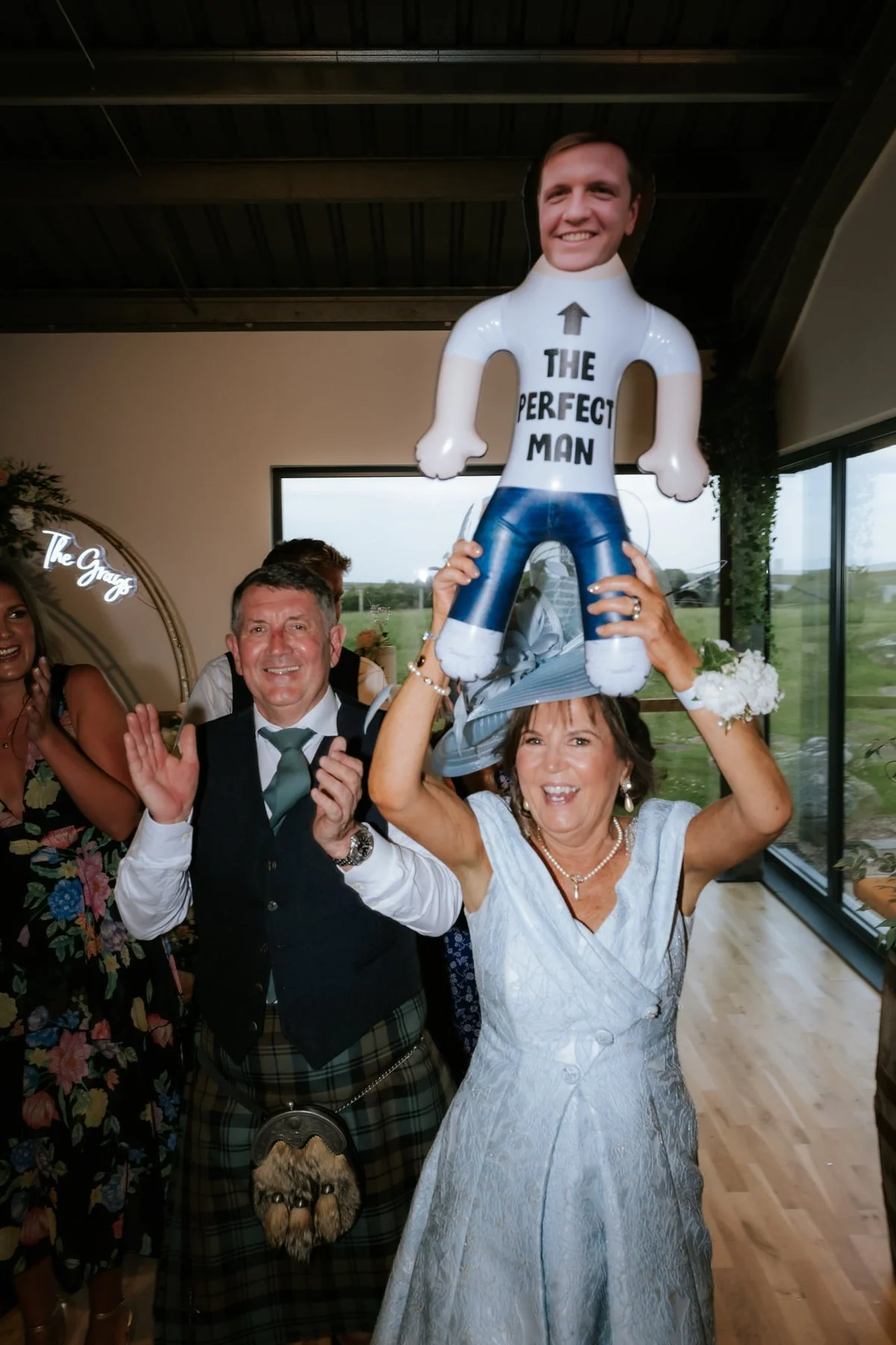 A guest holding an inflatable man above her head during the dinner entertainment.