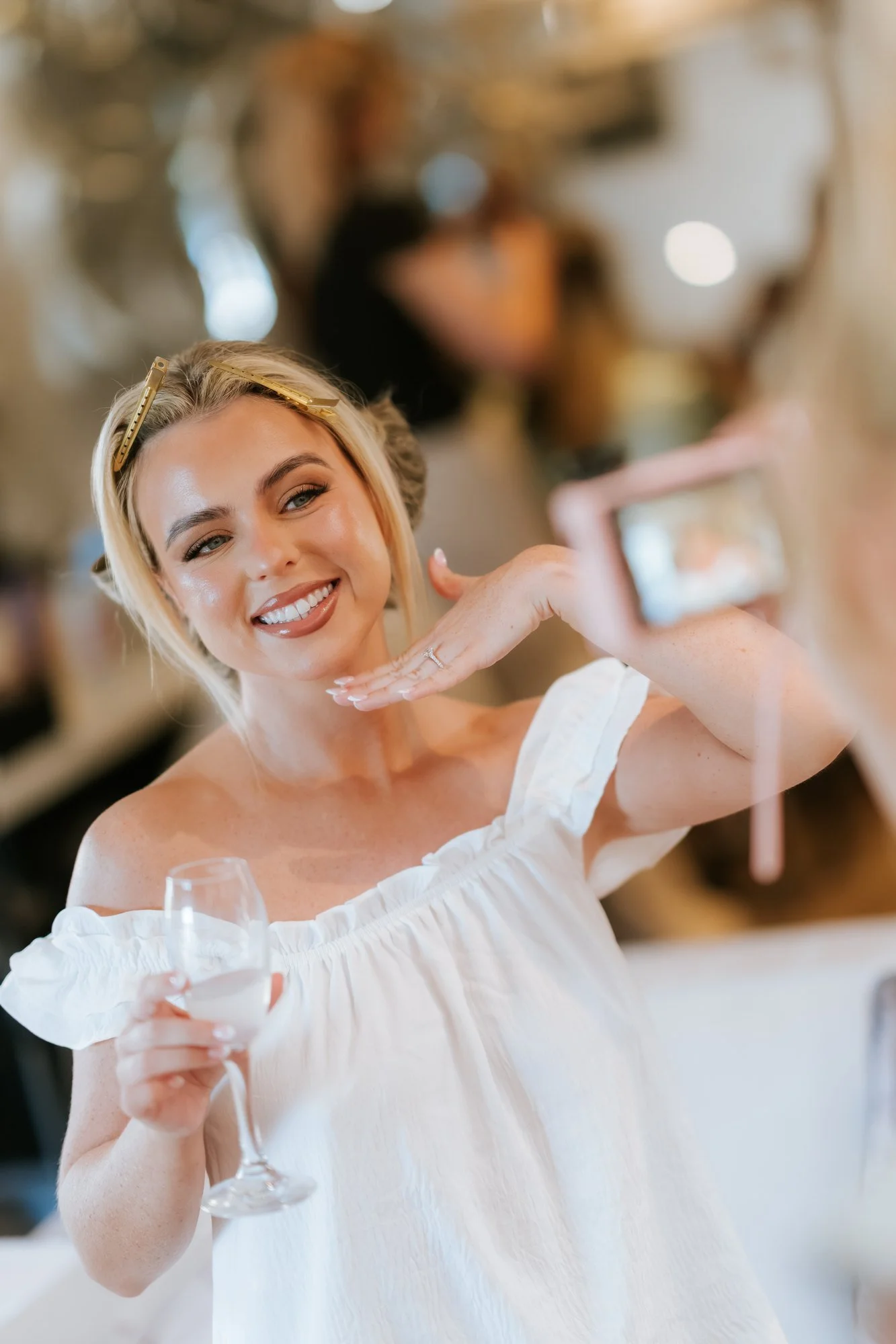 Taylor smiling with a glass during the wedding morning.