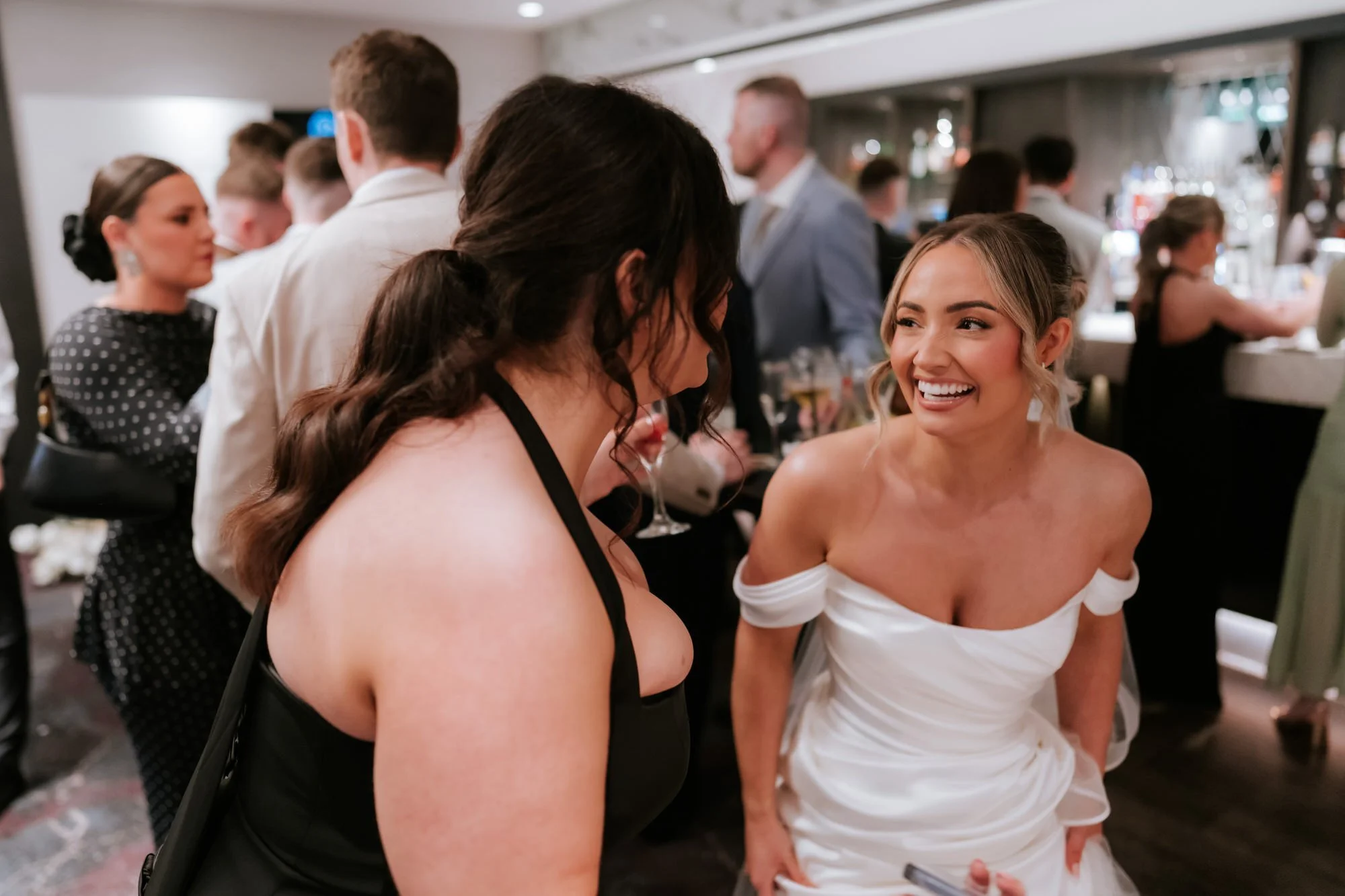 Elle laughing with a bridesmaid