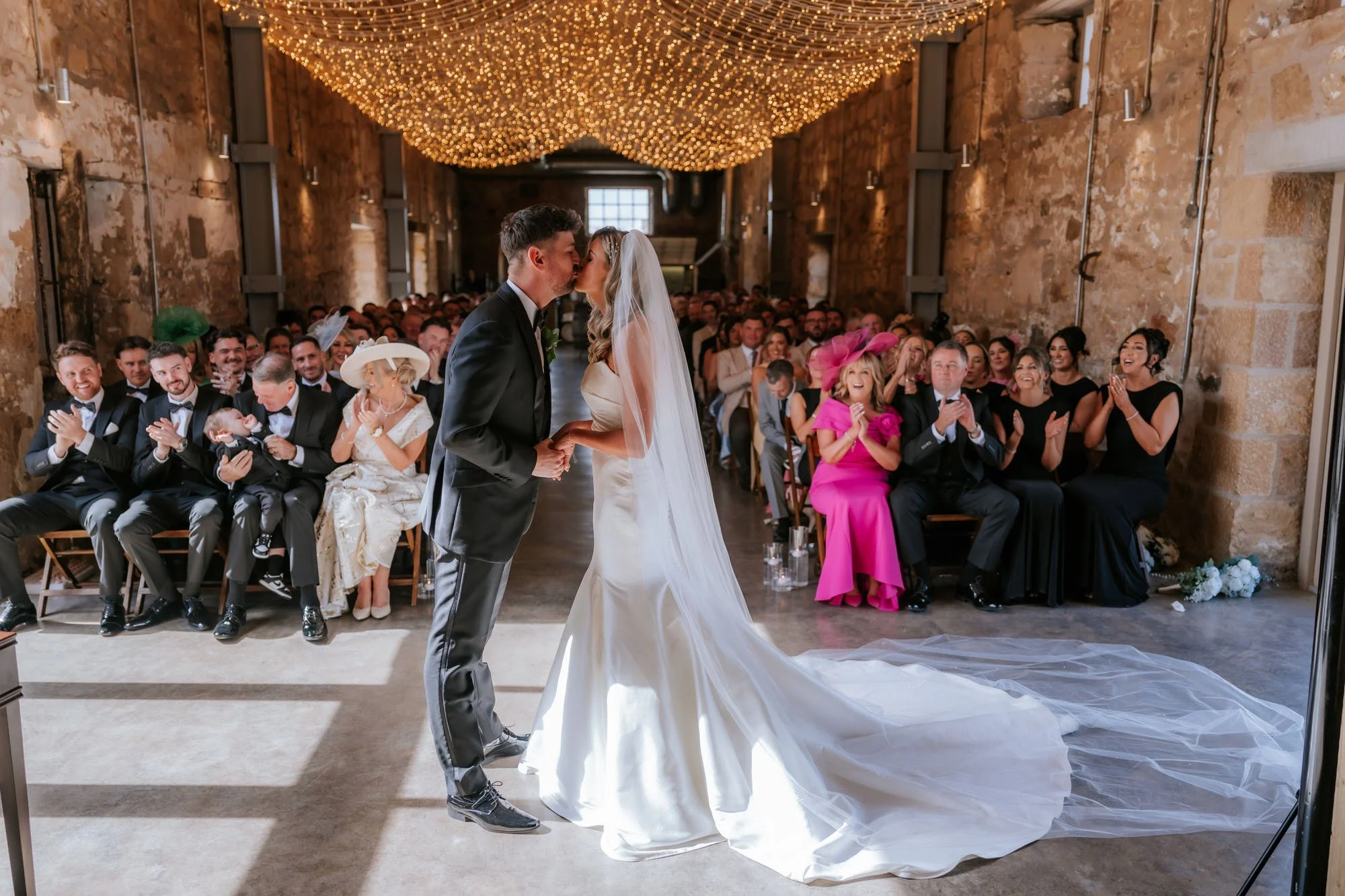 Natalie and Jamie kissing during their ceremony