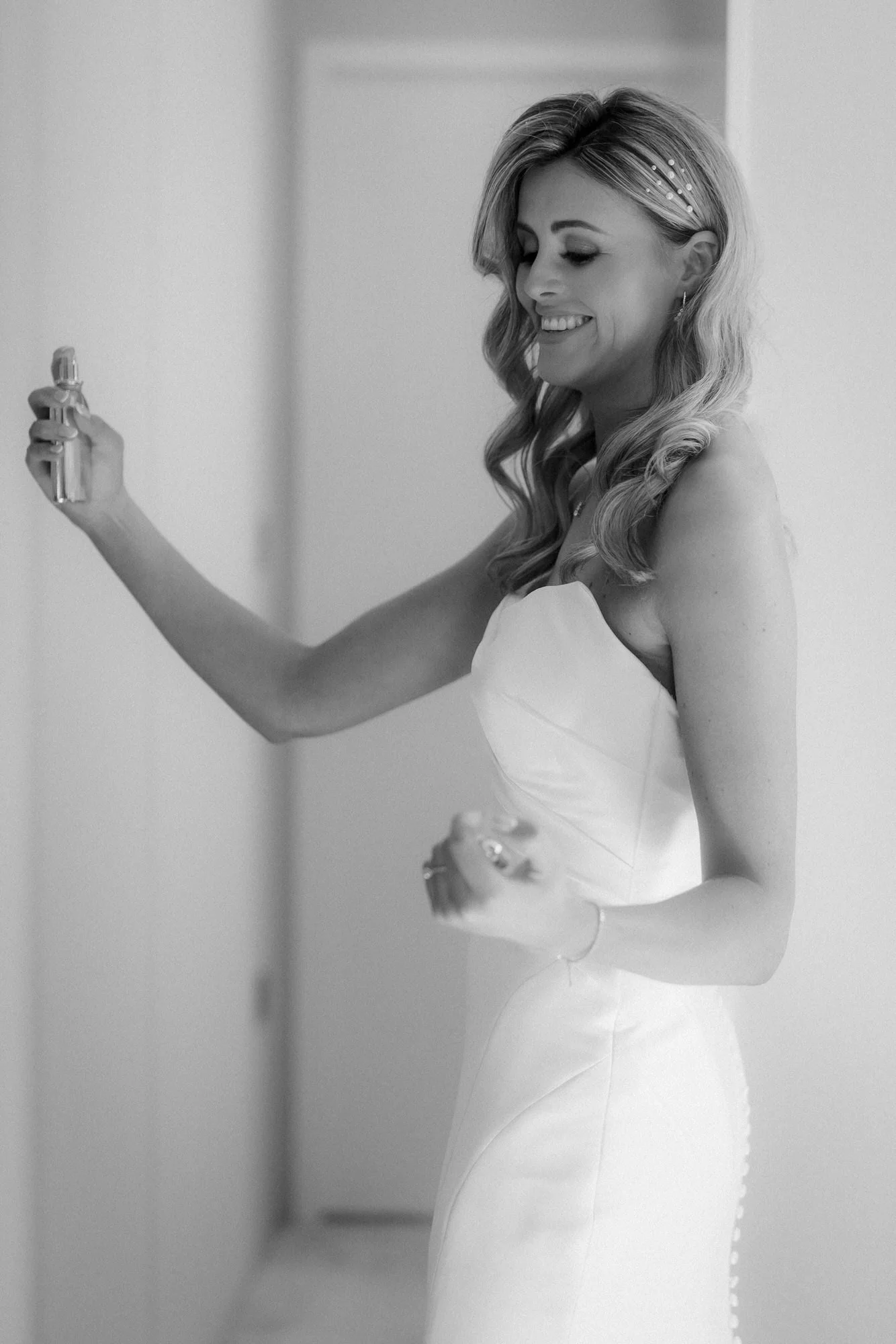 Natalie applying perfume before her wedding ceremony