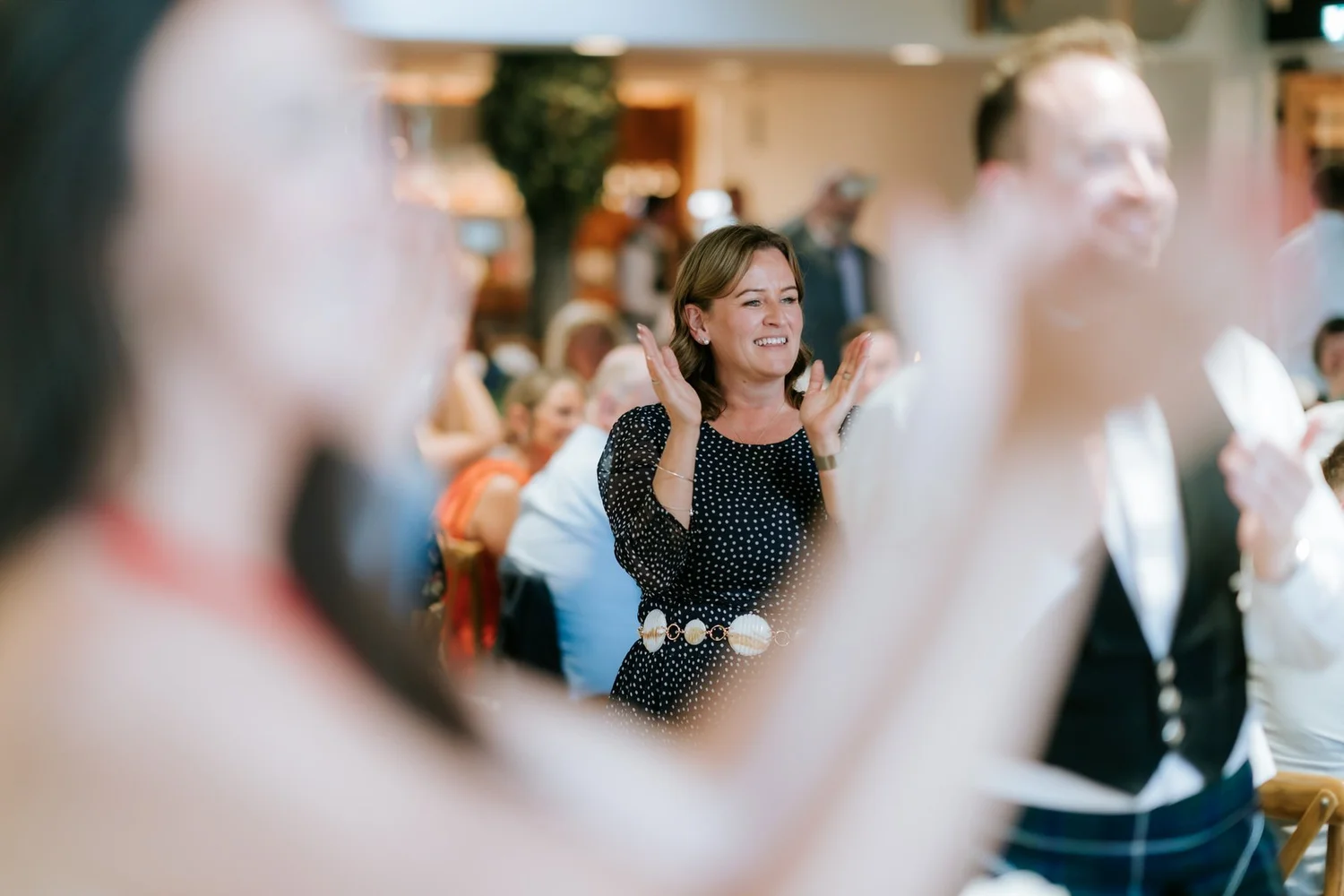Wedding guests clapping along during the dinner entertainment.