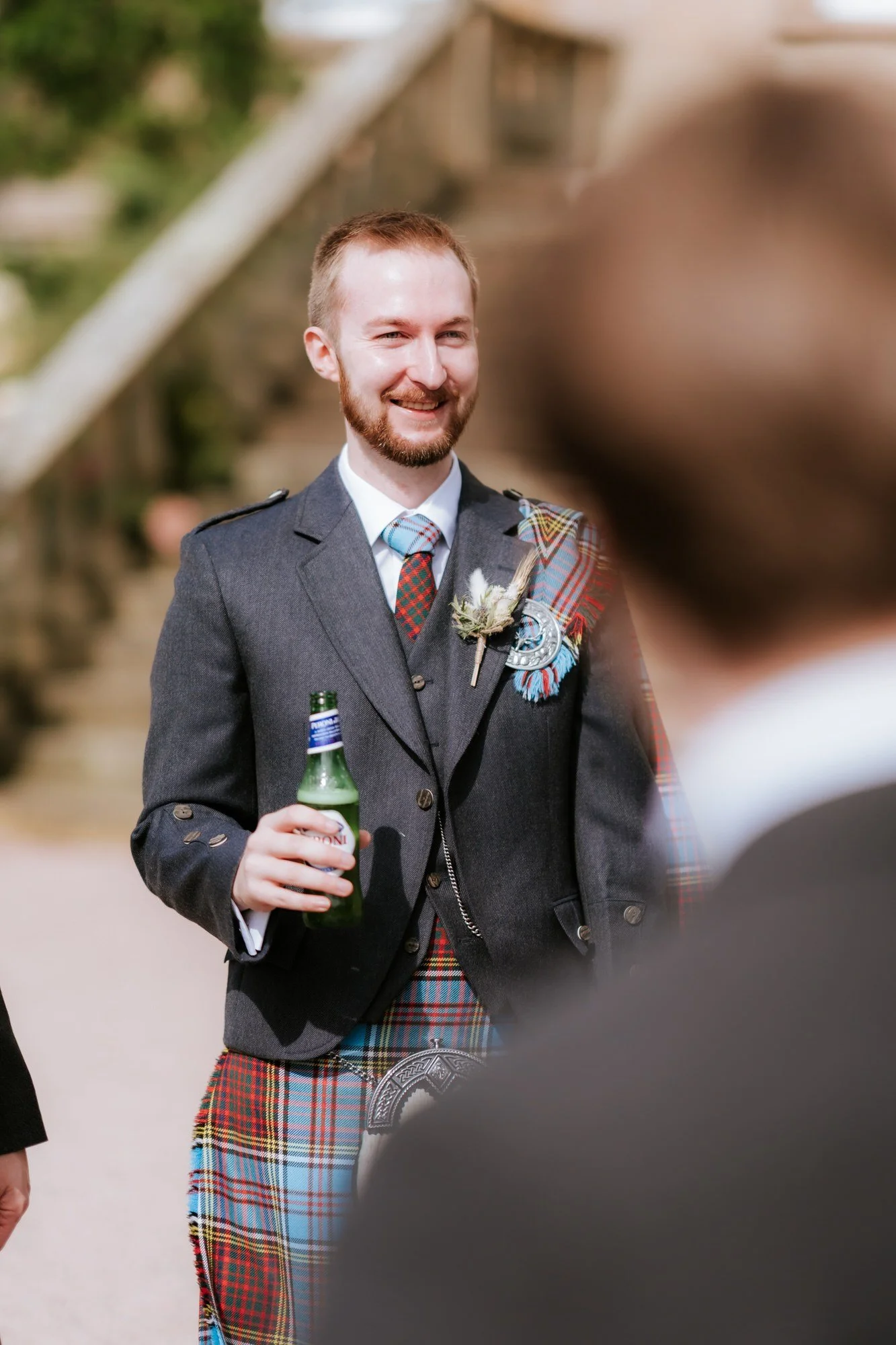 Jamie smiling with a drink before the ceremony.