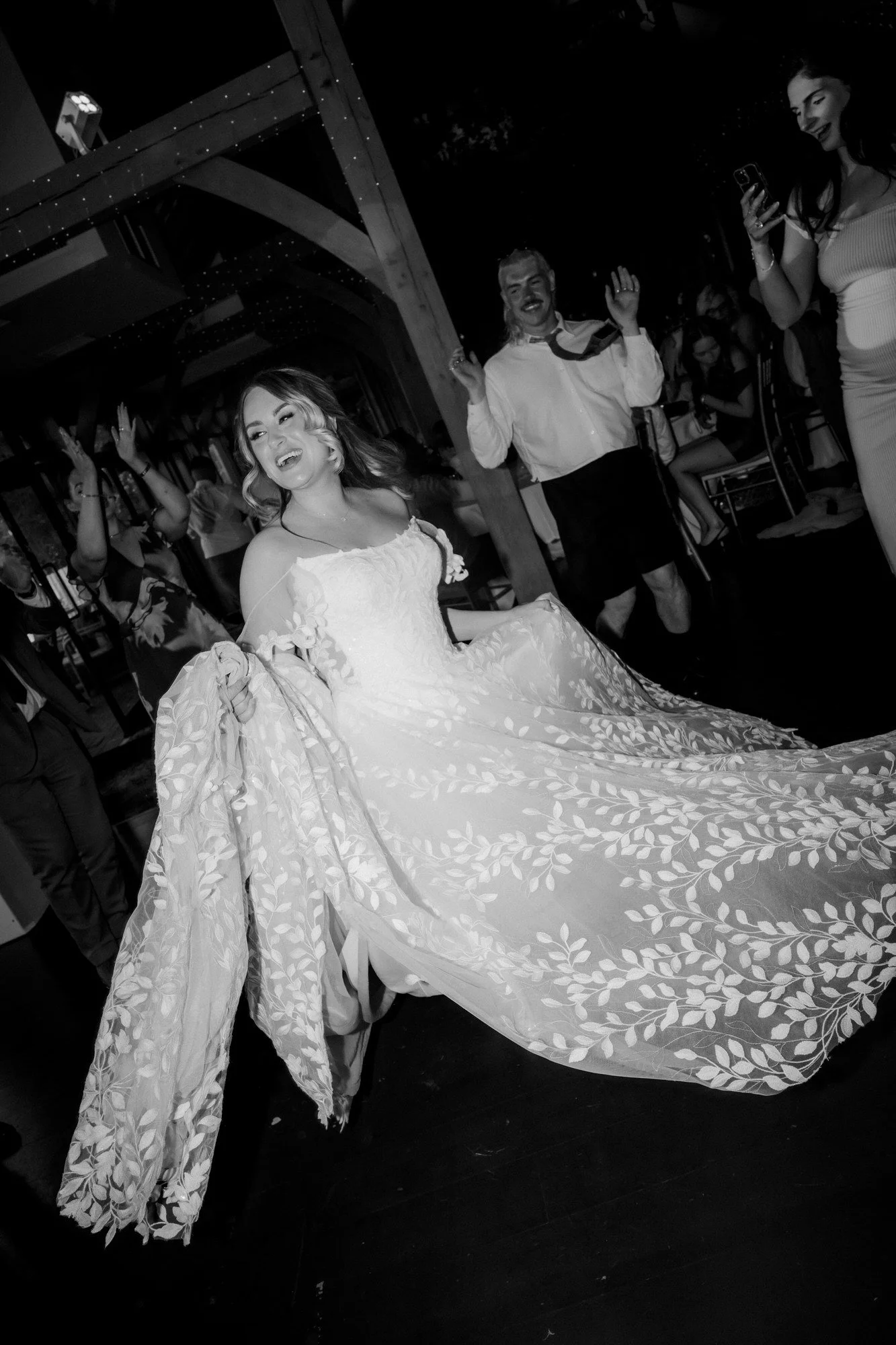 Ciara dancing with her wedding dress spread around her.