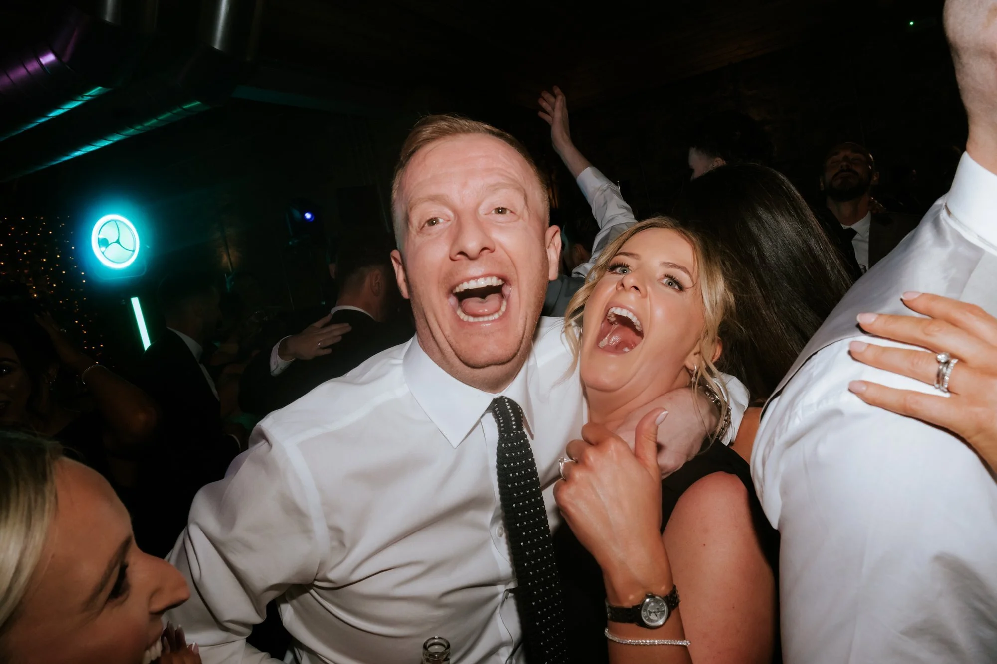Two guests cheering during the evening party