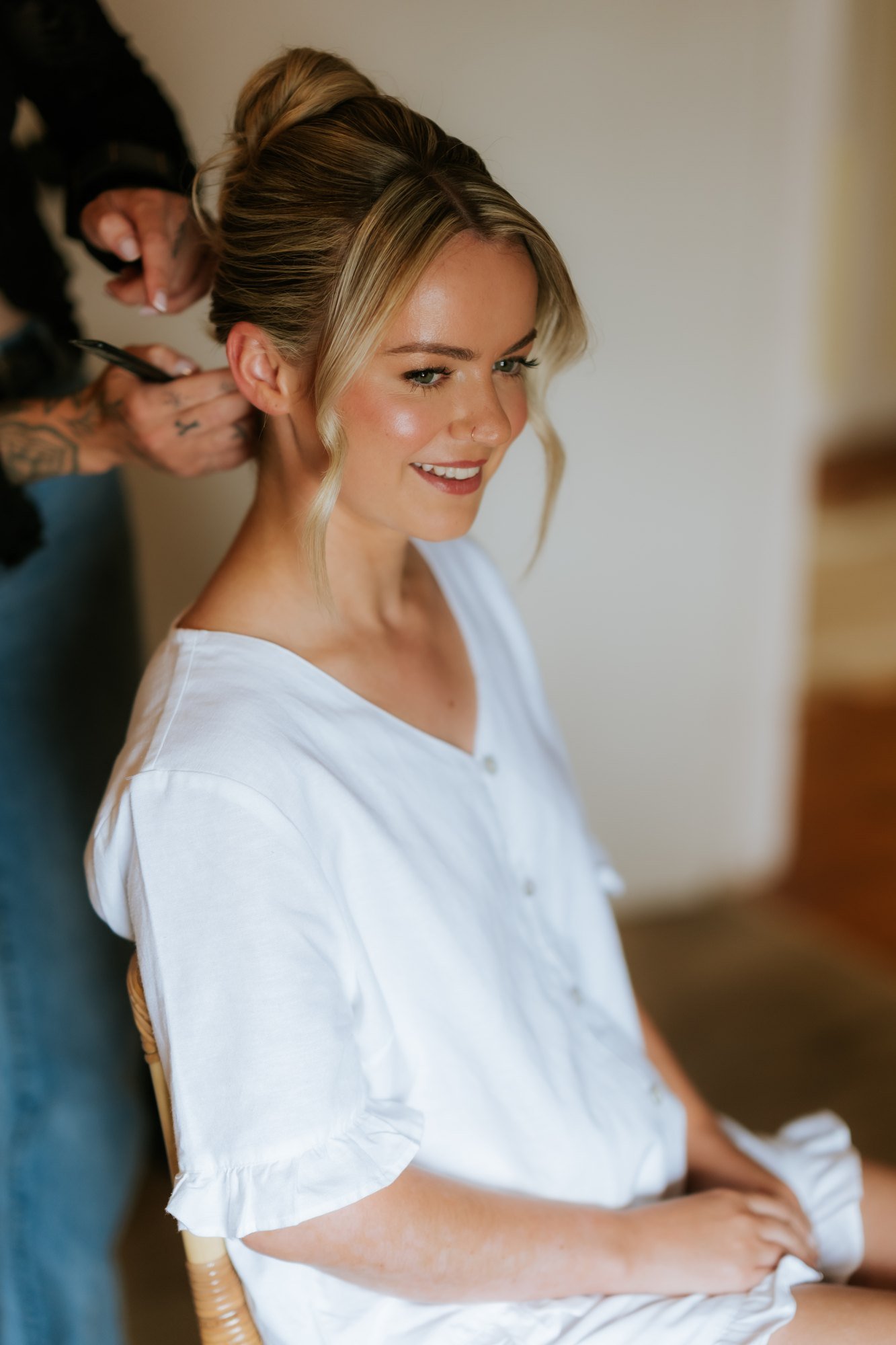 Lilian smiling while having her hair styled at Farmhall Farmhouse.