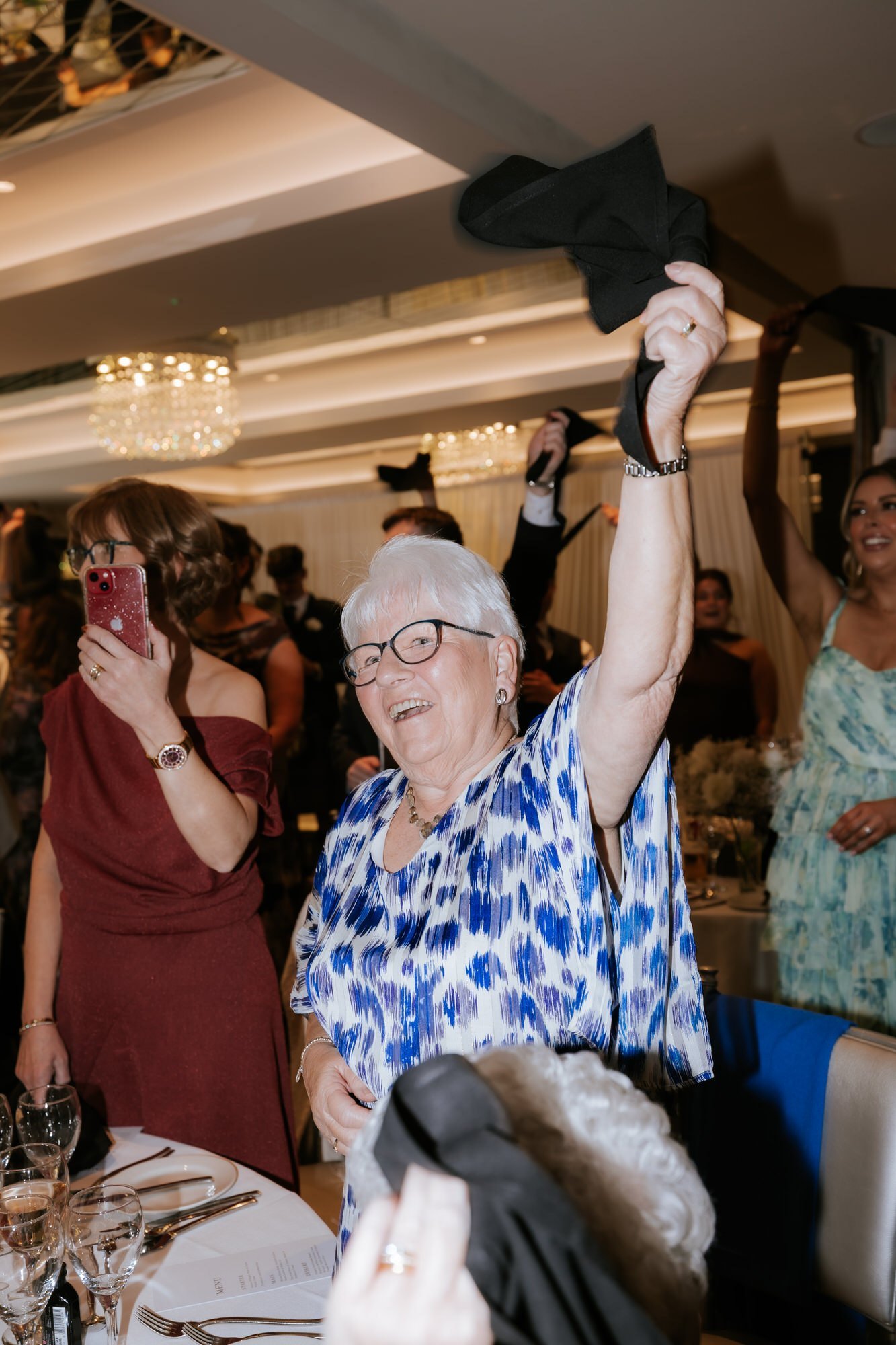 A wedding guest raising a napkin during the celebrations