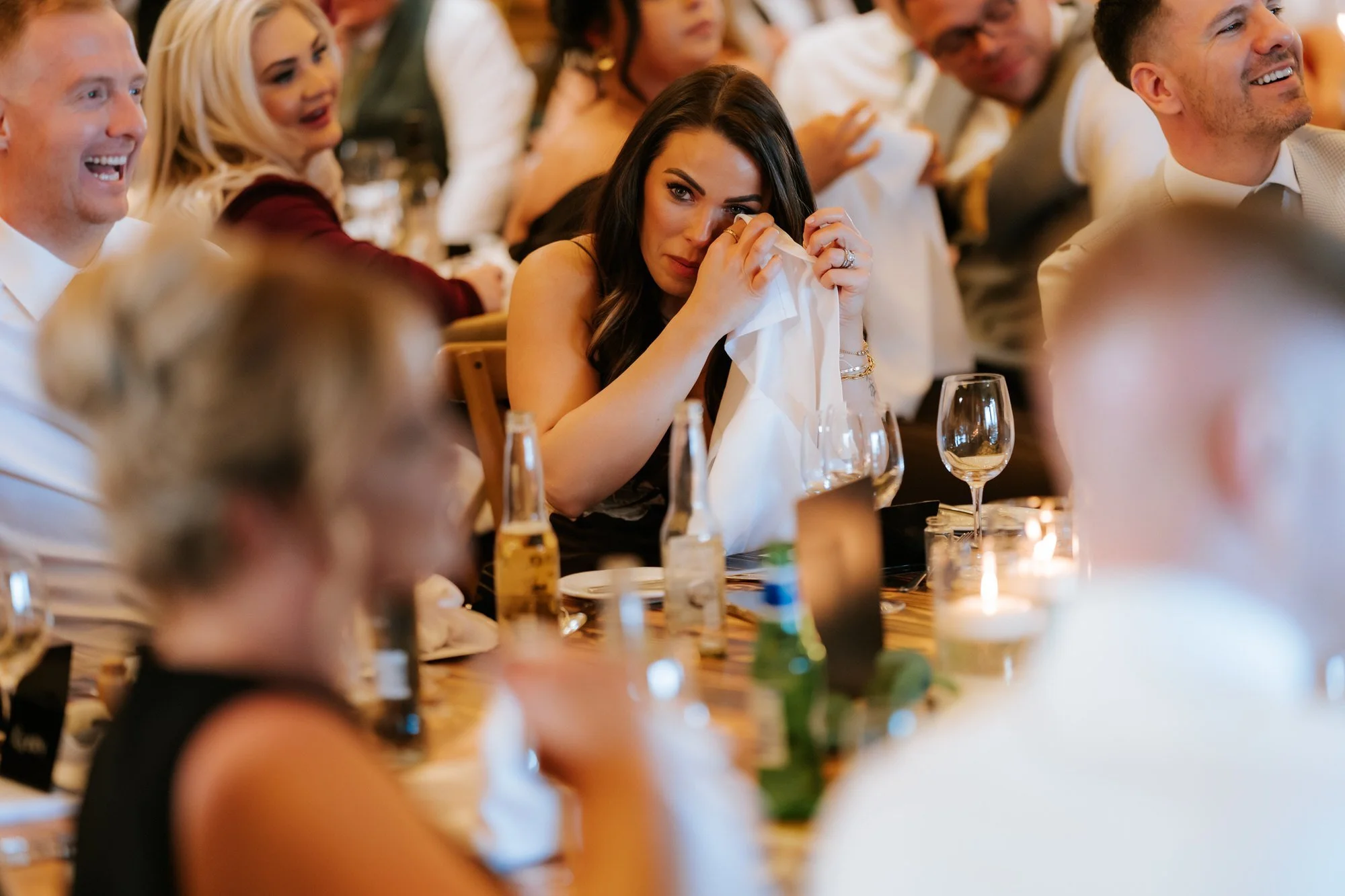 A guest holding a tissue during an emotional speech