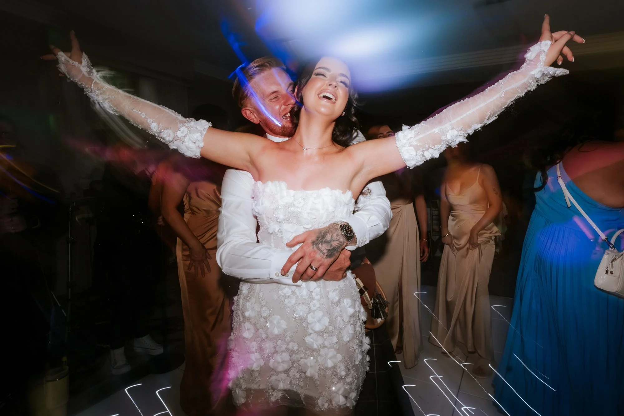 Scott embracing Kaitlyn as she dances with her arms outstretched at Glenbervie House.