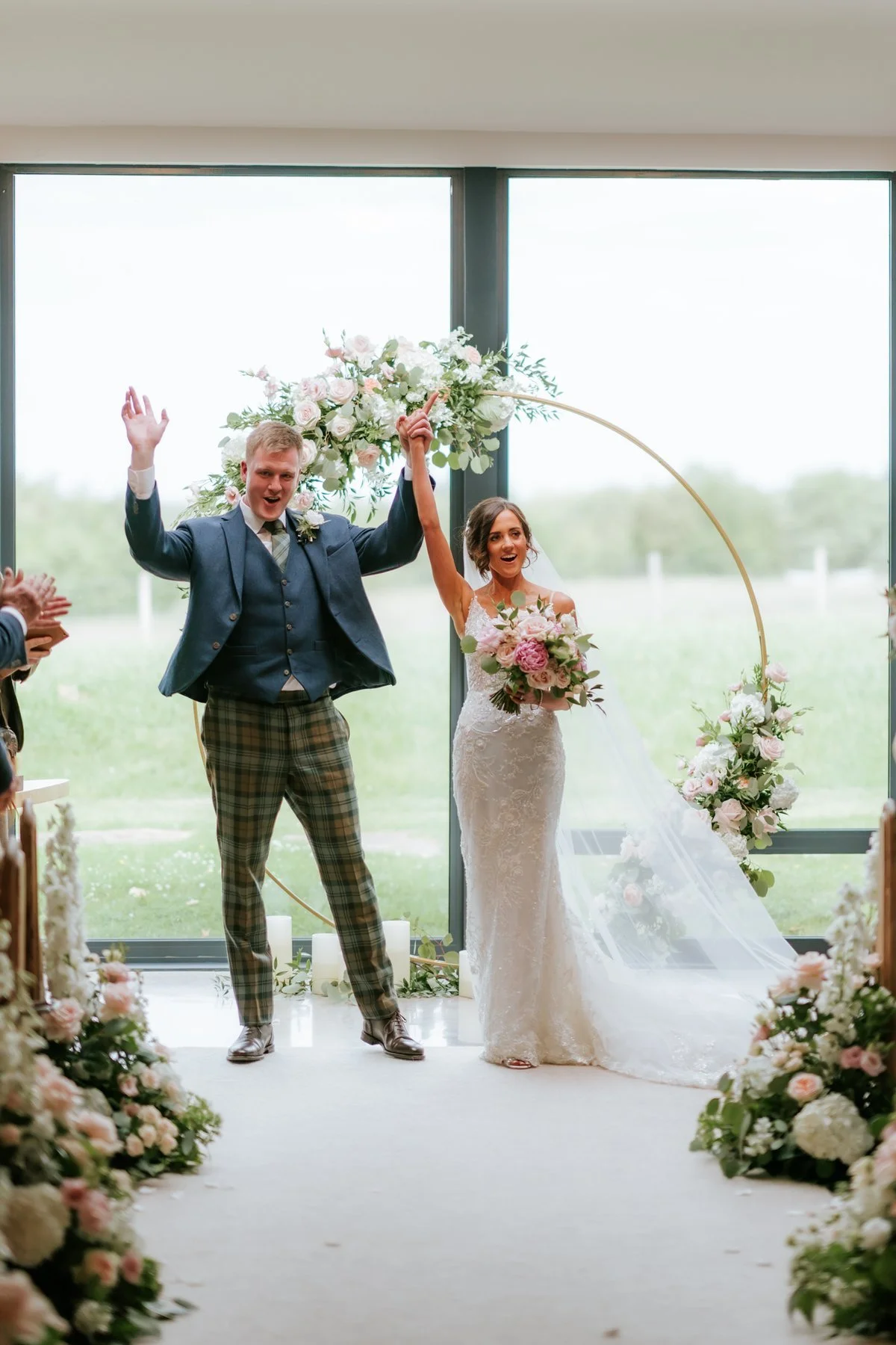 Jamie jumping with joy beside Lauren at the front of the ceremony room.
