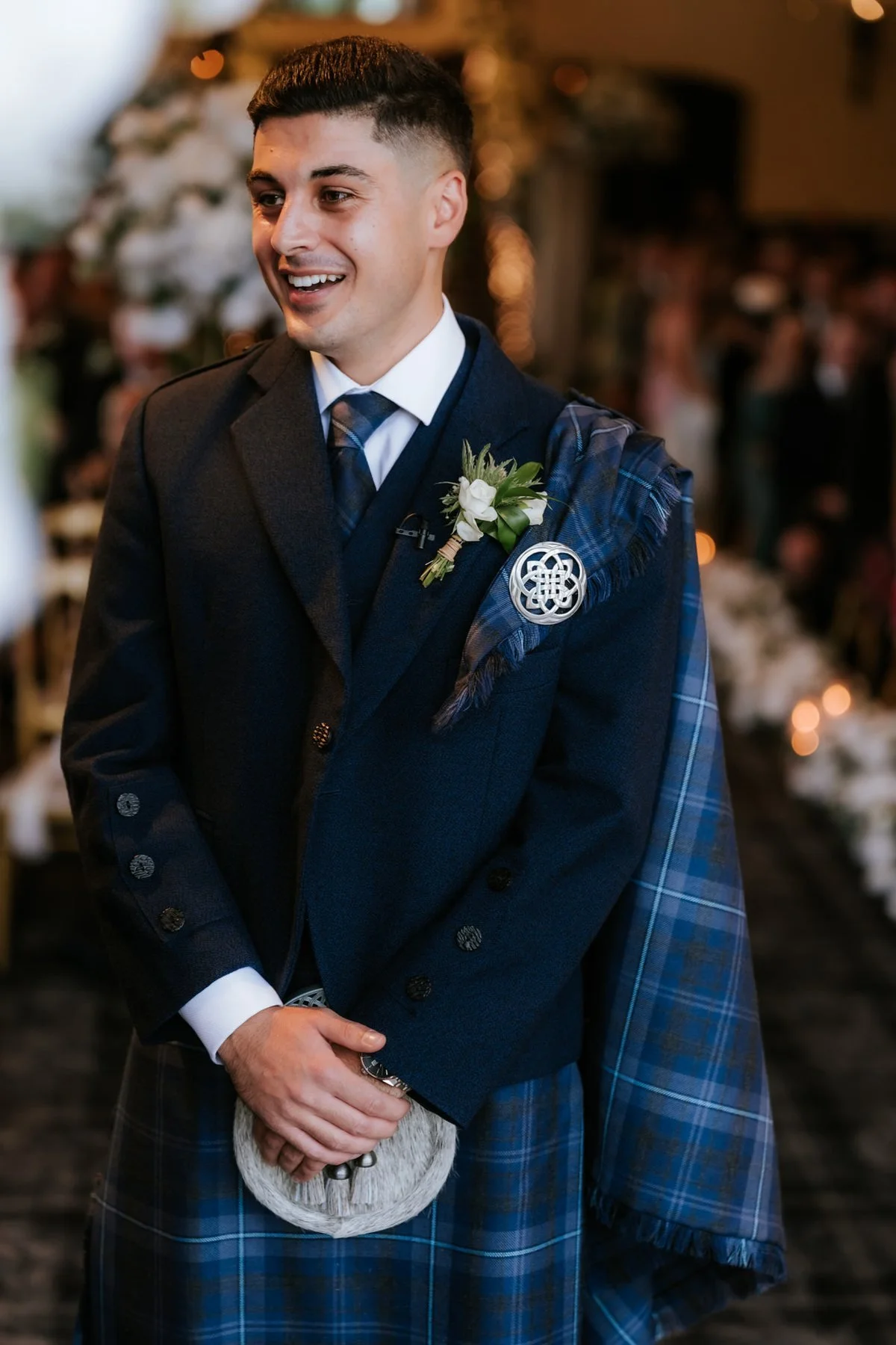Zen smiling as he waits at the front of the wedding ceremony.
