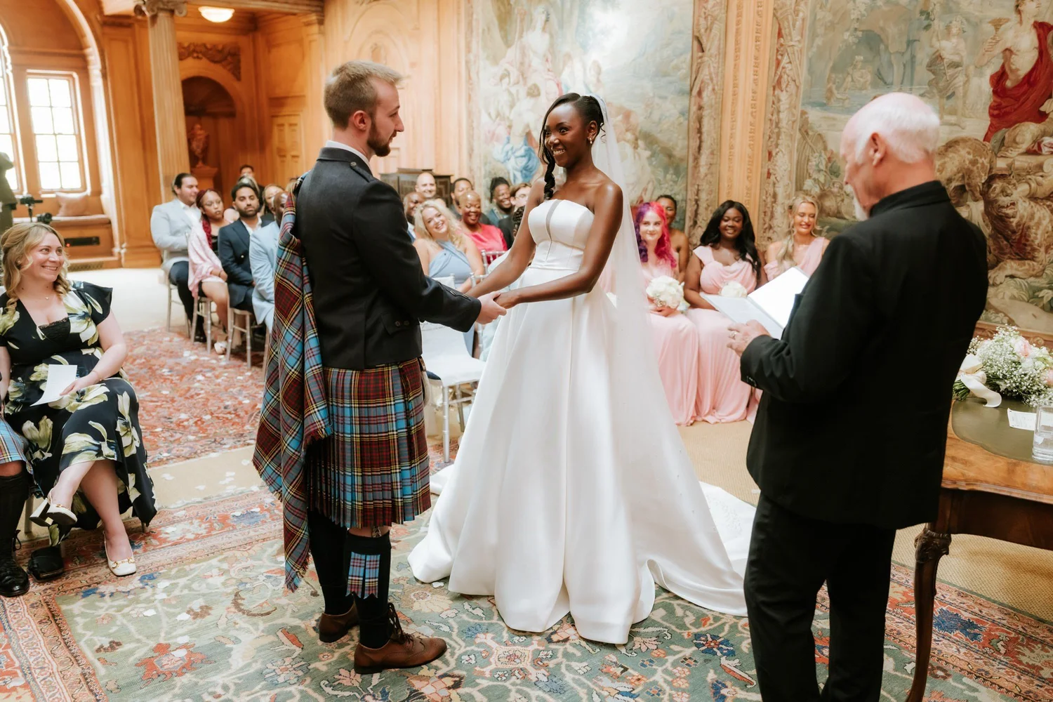 Kuda and Jamie holding hands during their wedding vows.