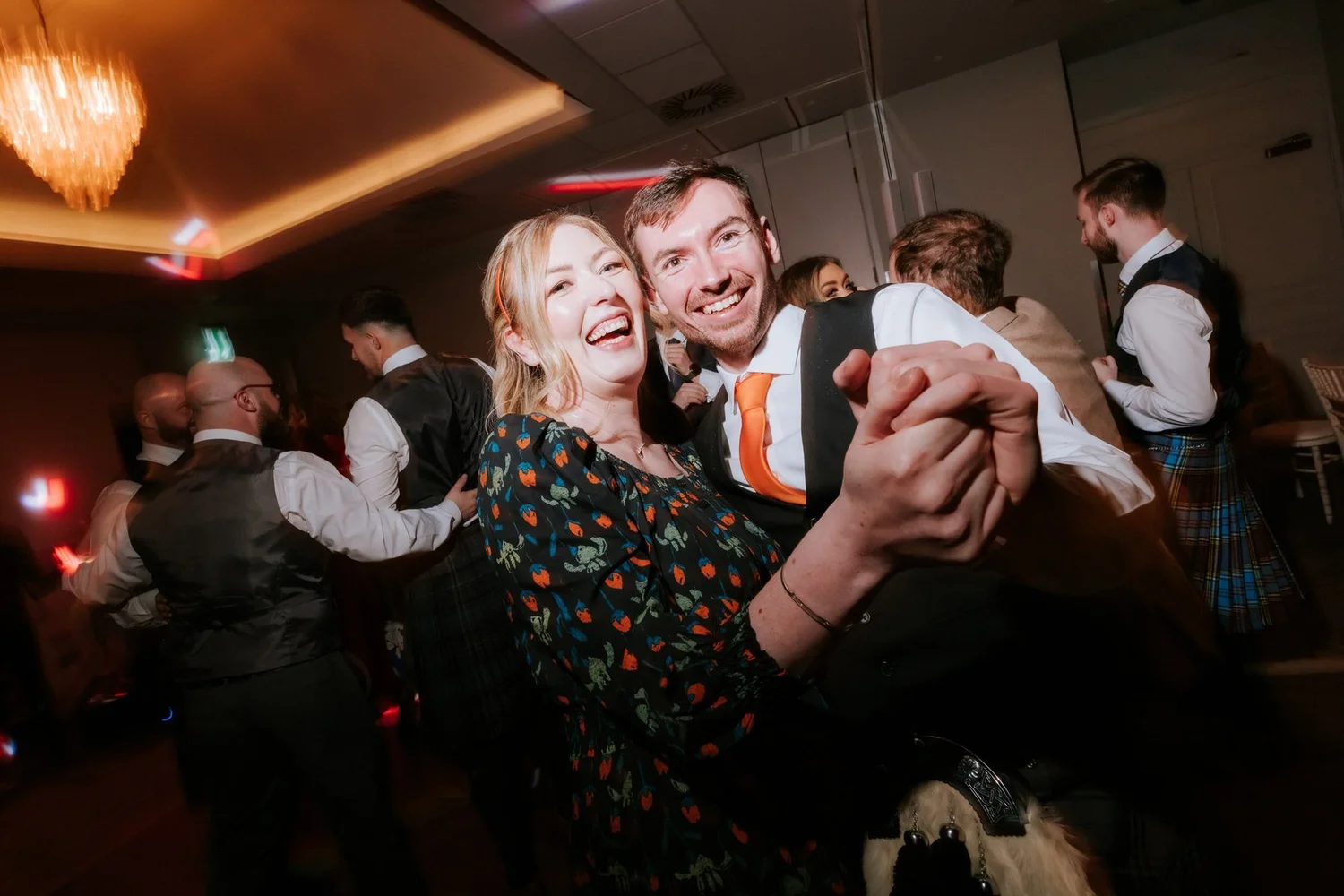 Two guests laughing together as they dance at Kendall and Ewen’s evening reception.