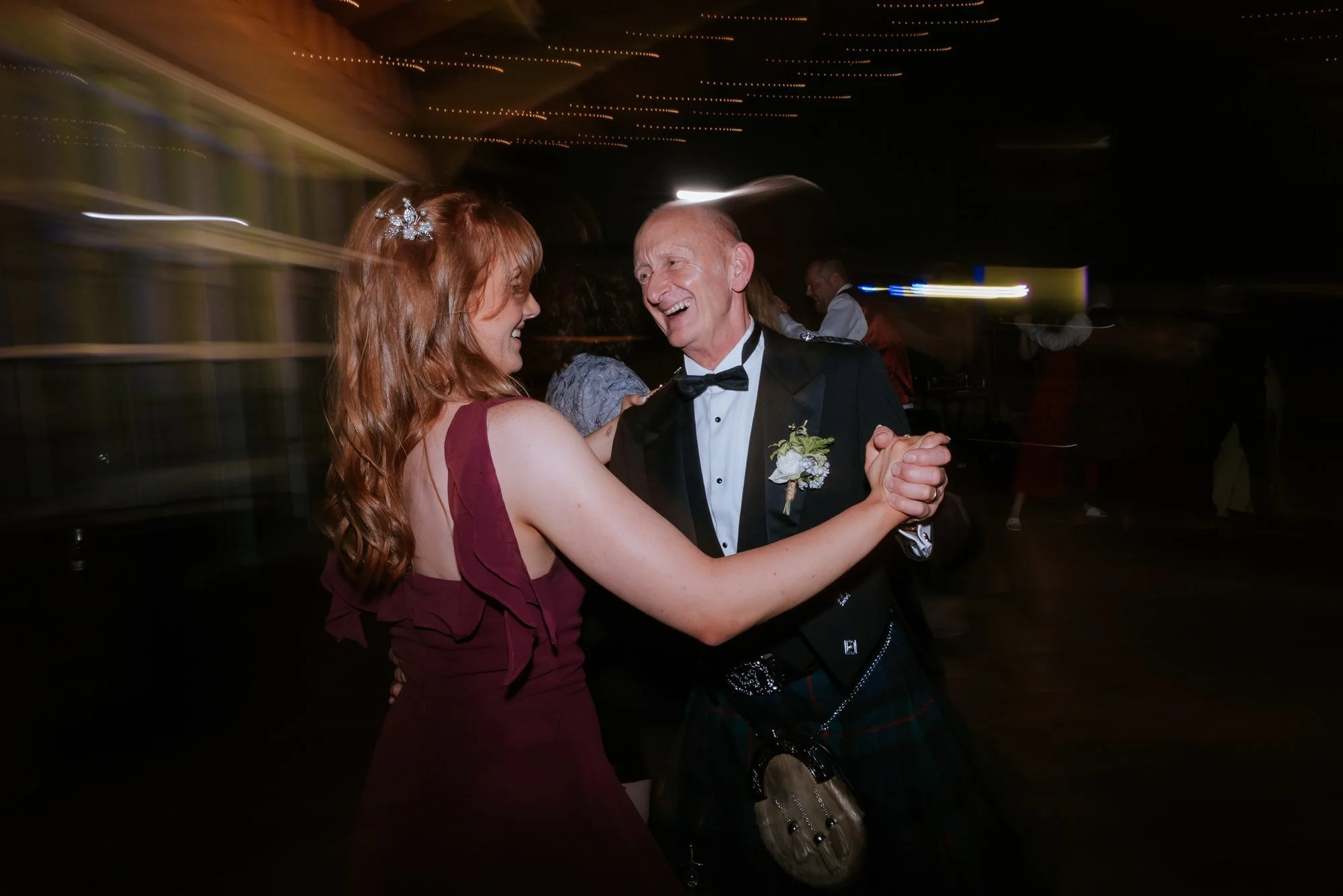 A couple spinning together during the wedding ceilidh.