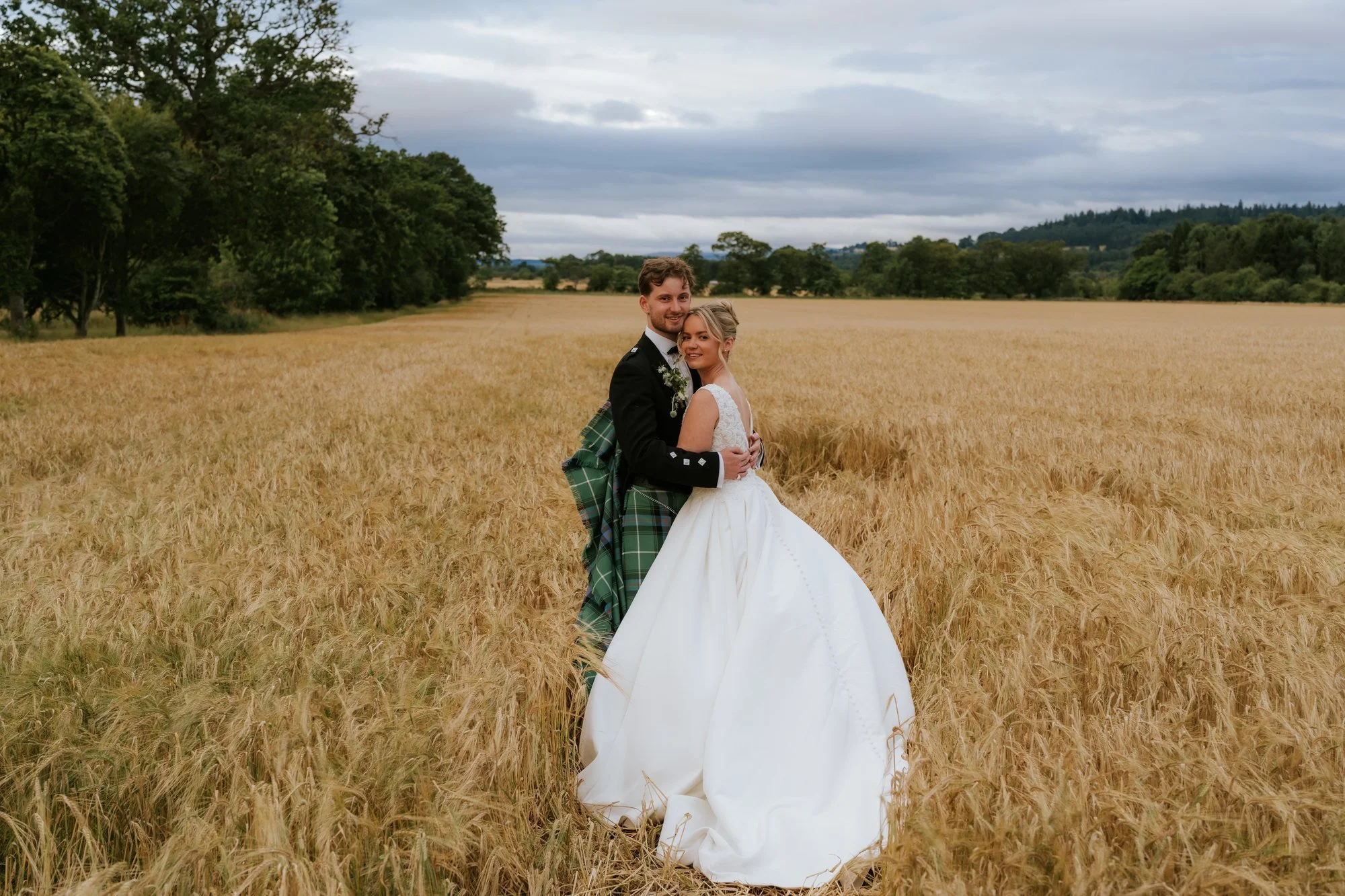 Lilian and Luke embracing in the Perthshire fields at Rossie on the Earn.