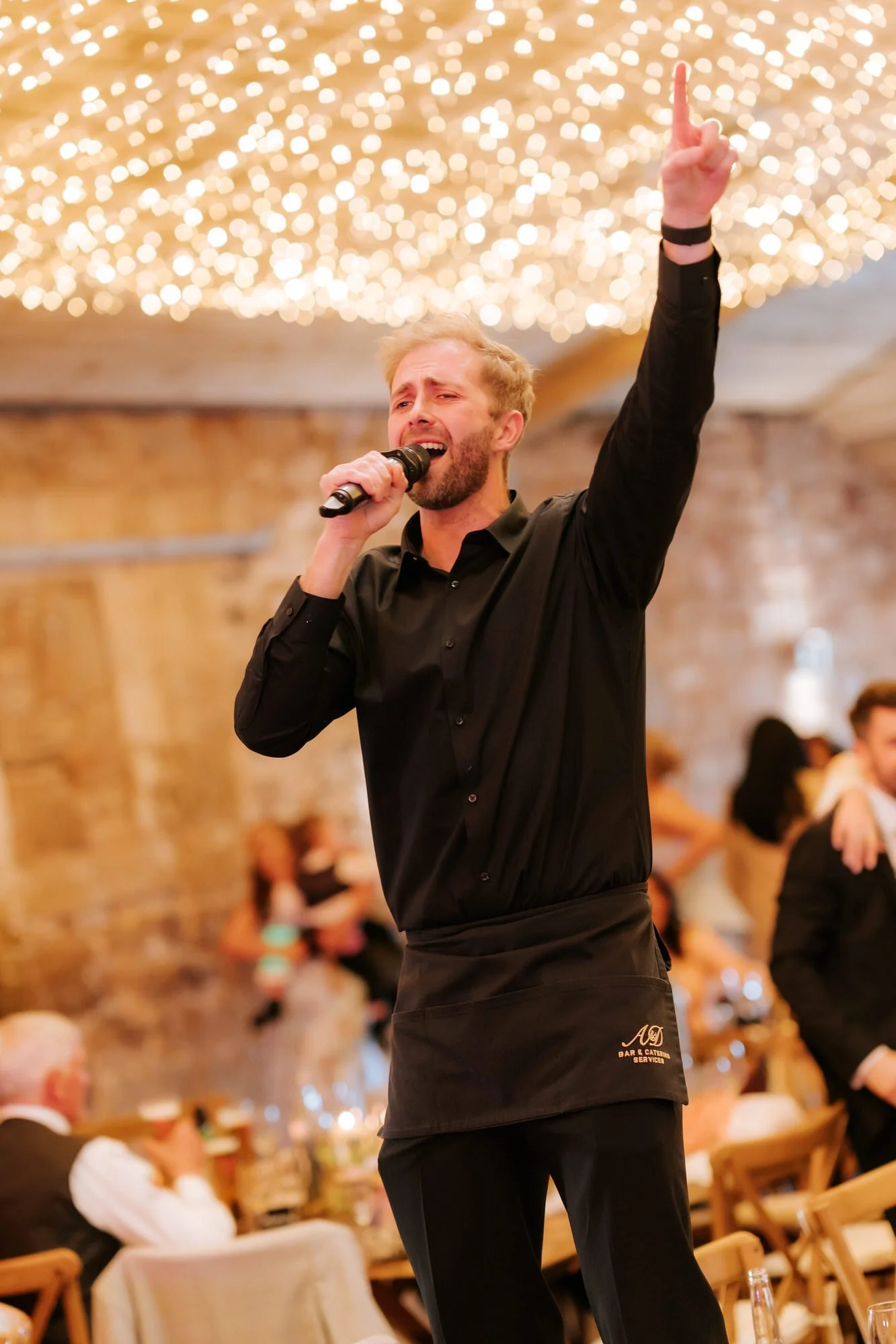 A singing waiter entertaining guests at Falside Mill