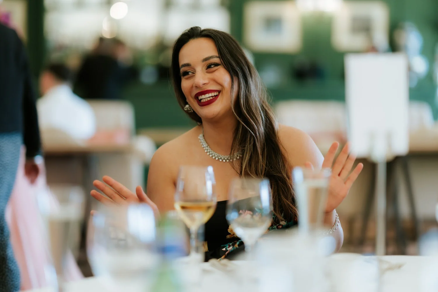 A guest laughing at her table during Kuda and Jamie’s wedding reception.