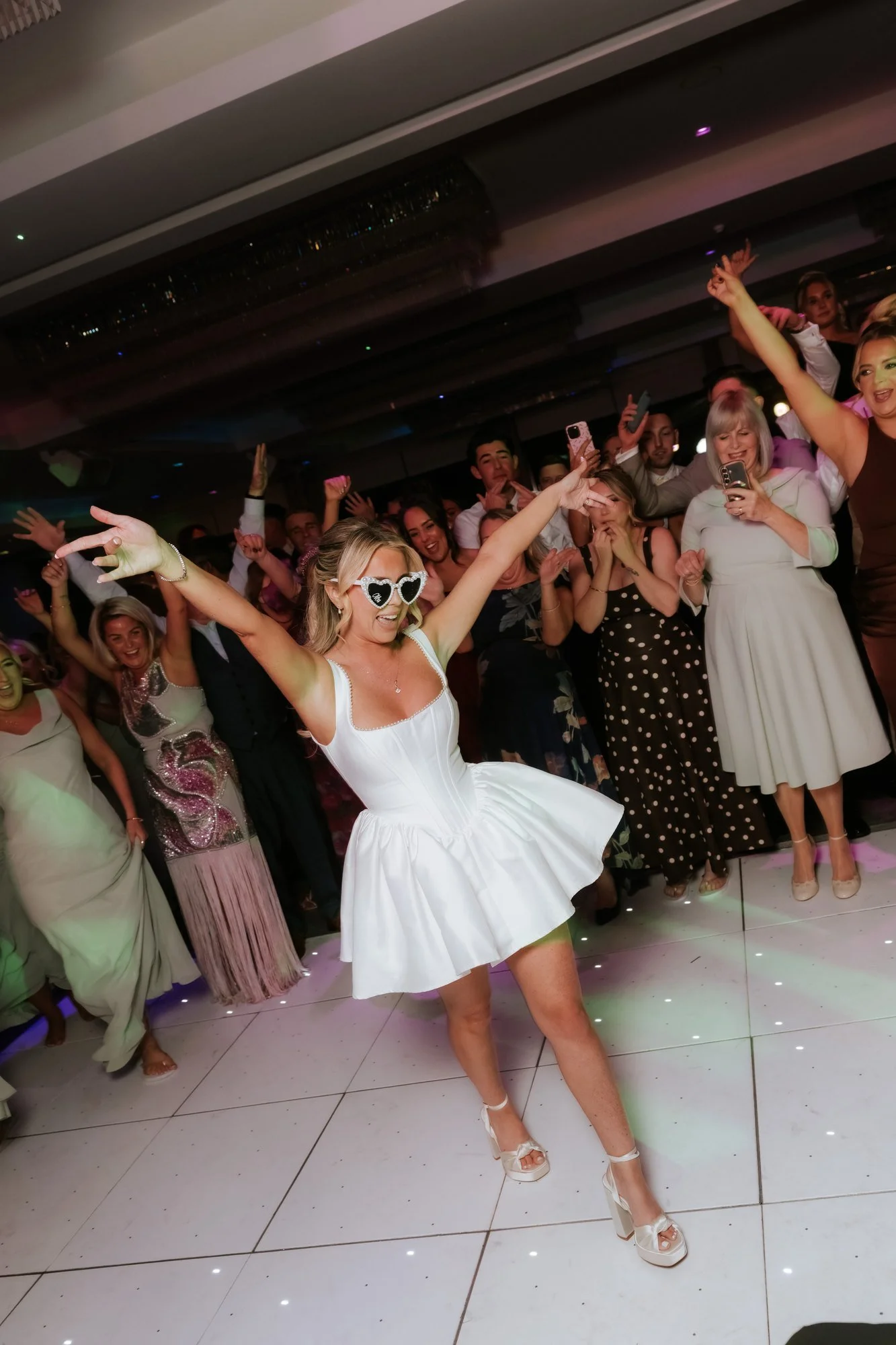 Taylor celebrating on the dance floor in her evening dress.
