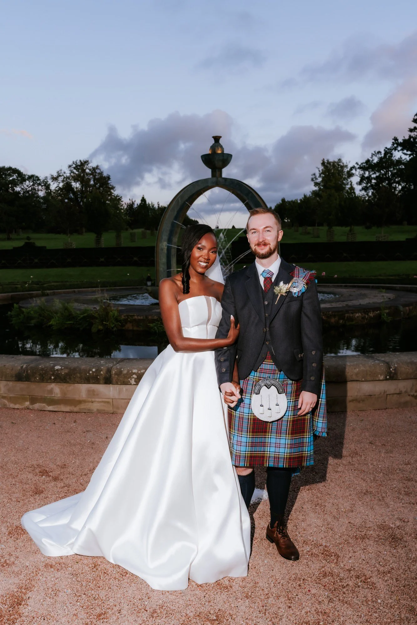 Kuda and Jamie together beside the fountain as evening falls.
