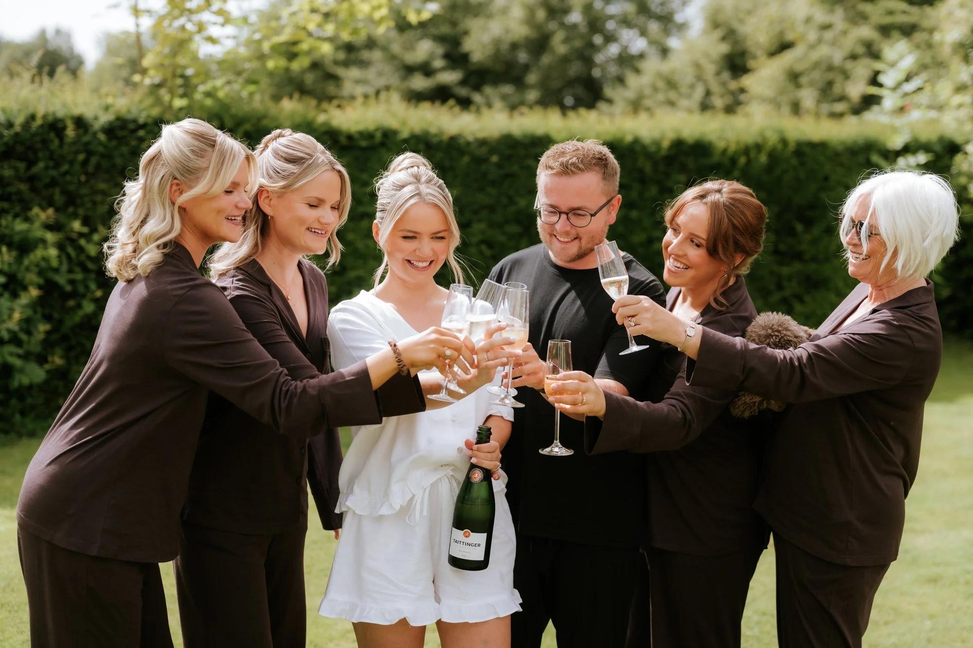 Lilian and her bridal party raising their glasses in the garden before the wedding.