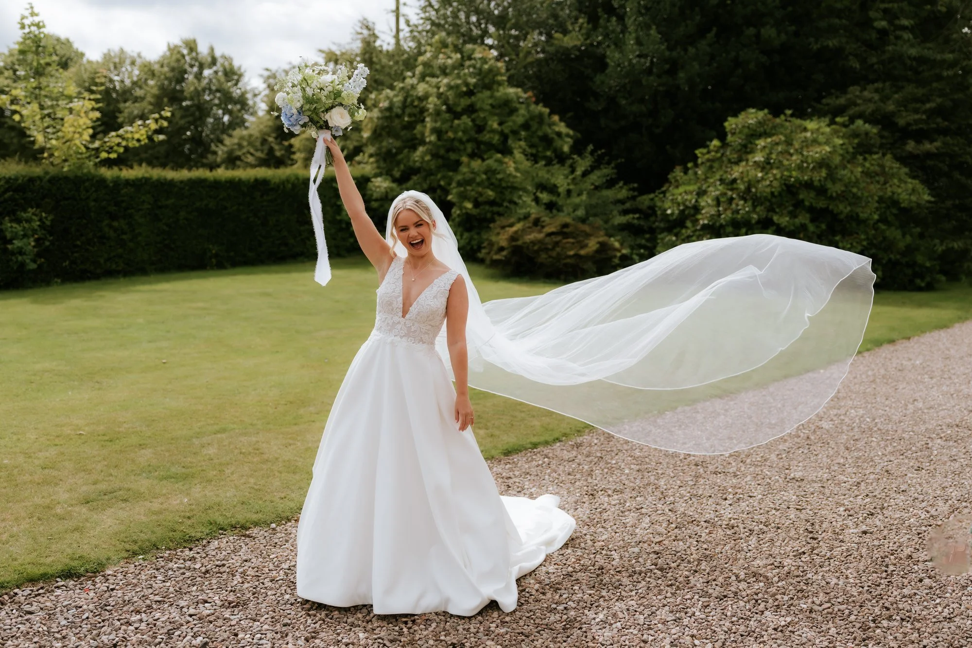 Lilian lifting her veil in the breeze outside Farmhall Farmhouse.