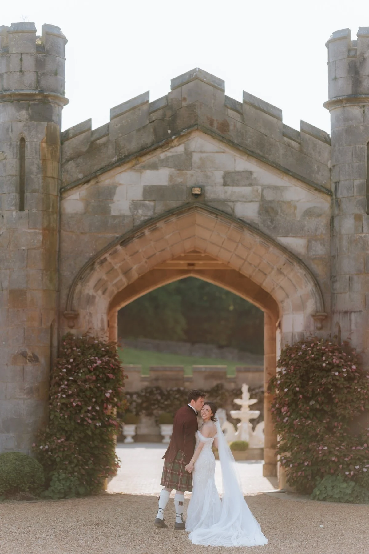 Kim and Kenneth standing beneath the stone archway at Dundas Castle.