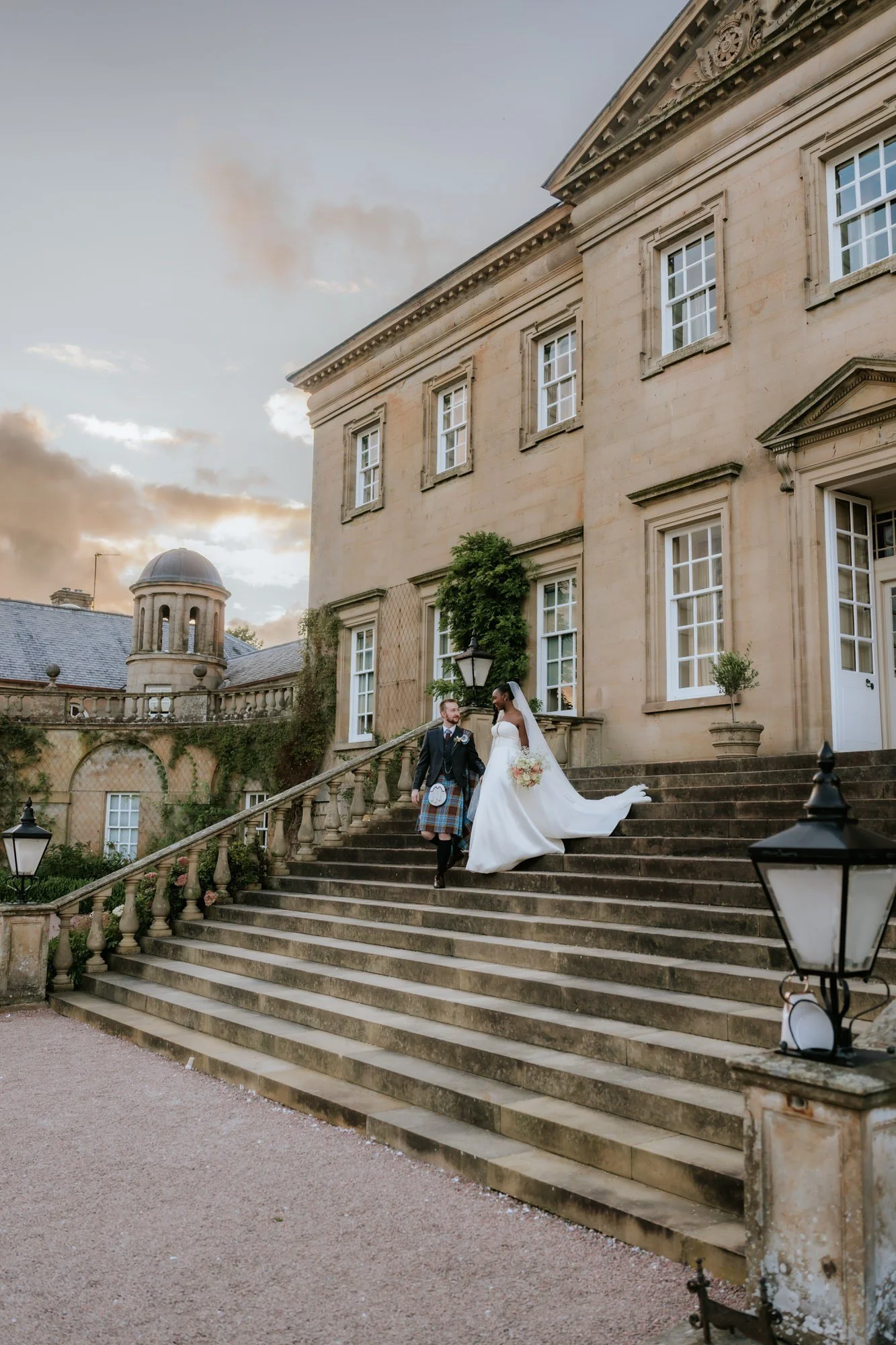 Kuda and Jamie descending the stone staircase outside Dumfries House.