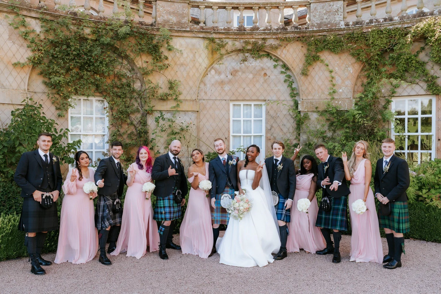 Kuda, Jamie and their wedding party having fun in the gardens.
