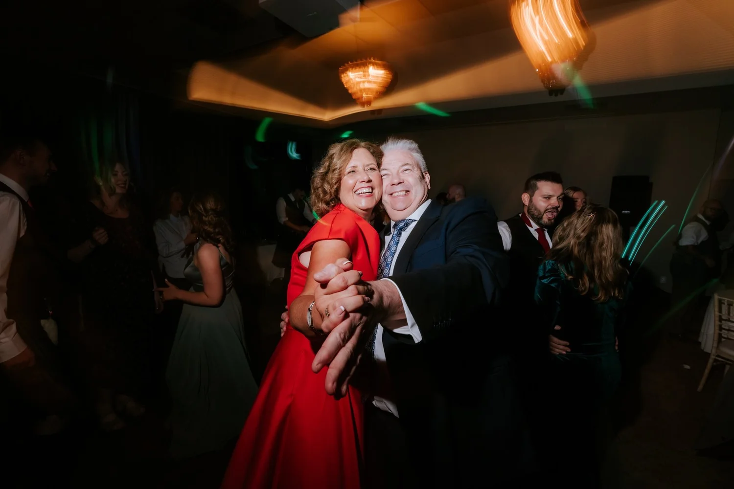 Two guests dancing closely together at the wedding party.