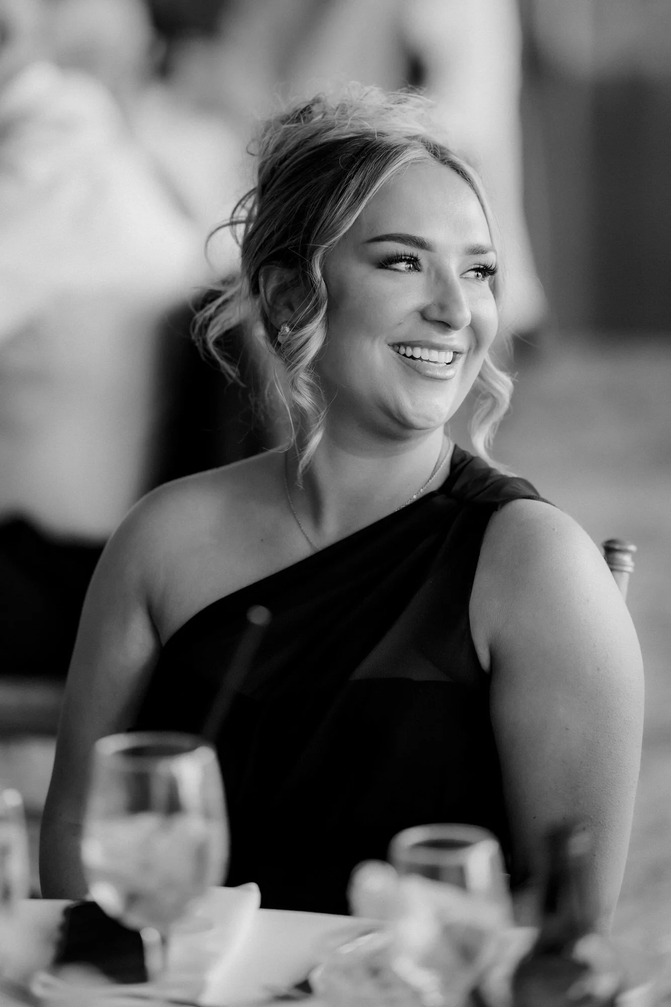 A bridesmaid laughing at the wedding breakfast.