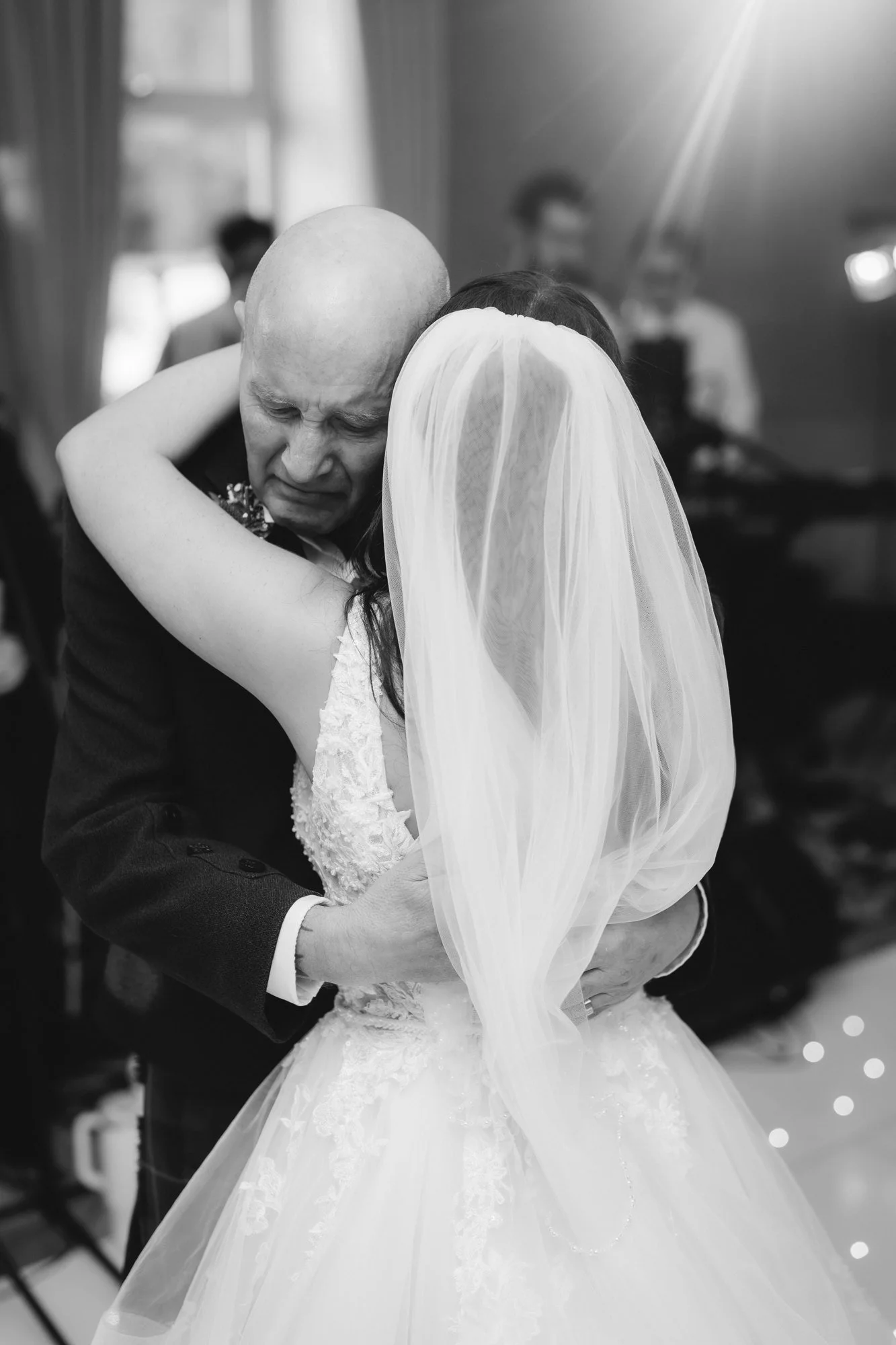 An emotional embrace with Kaitlyn on the dance floor, in black and white at Glenbervie House.
