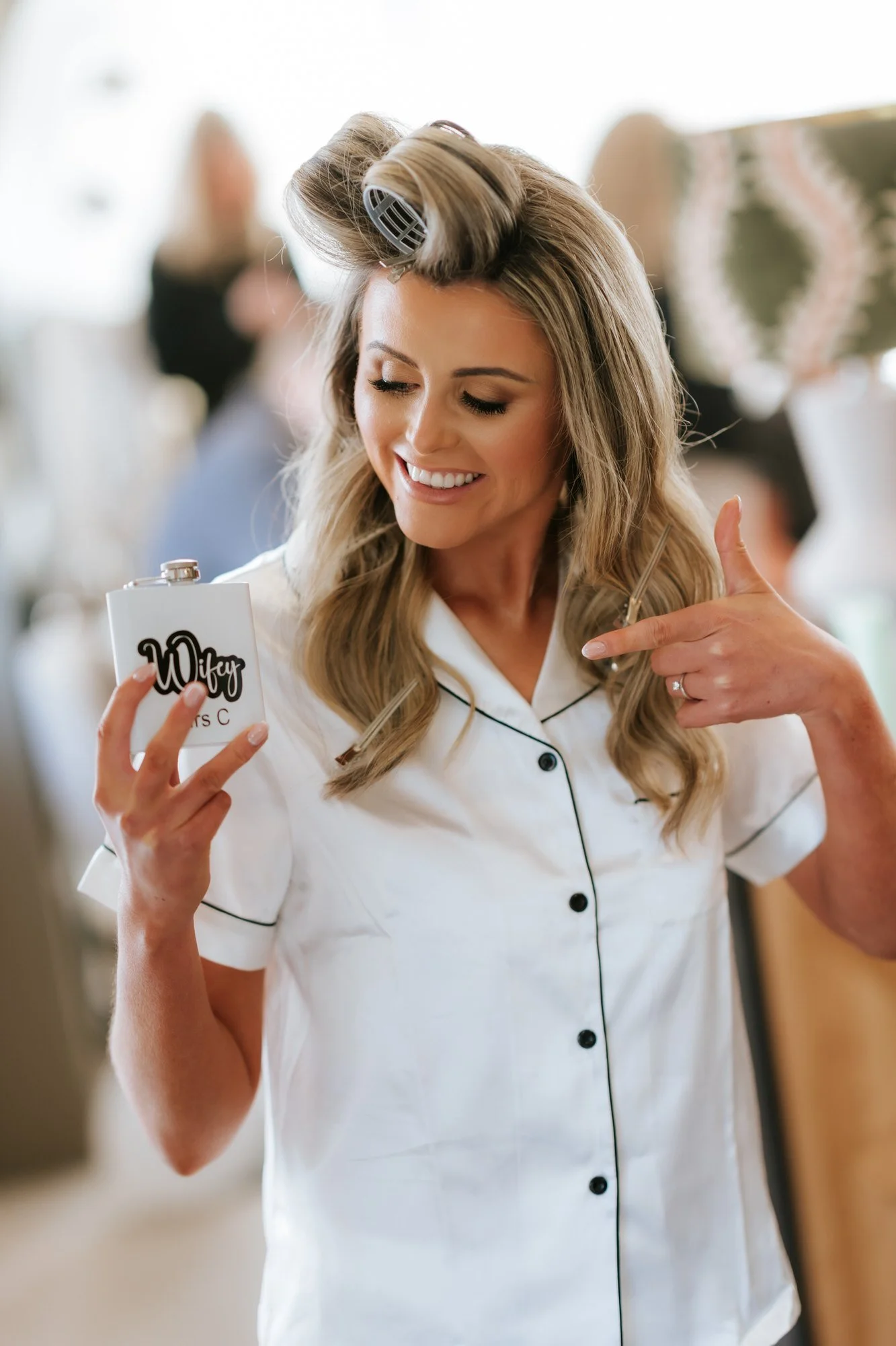 Natalie smiling at her personalised Wifey flask during the wedding morning