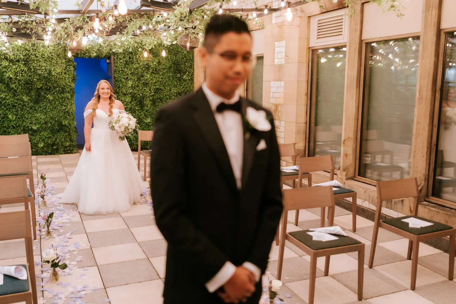 Allie approaching Carl from behind for their first look in the Garden Suite.