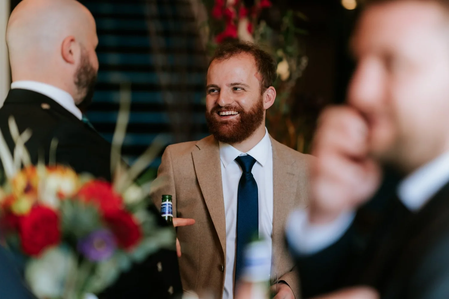 Ewen chatting to a laughing guest during the drinks reception.